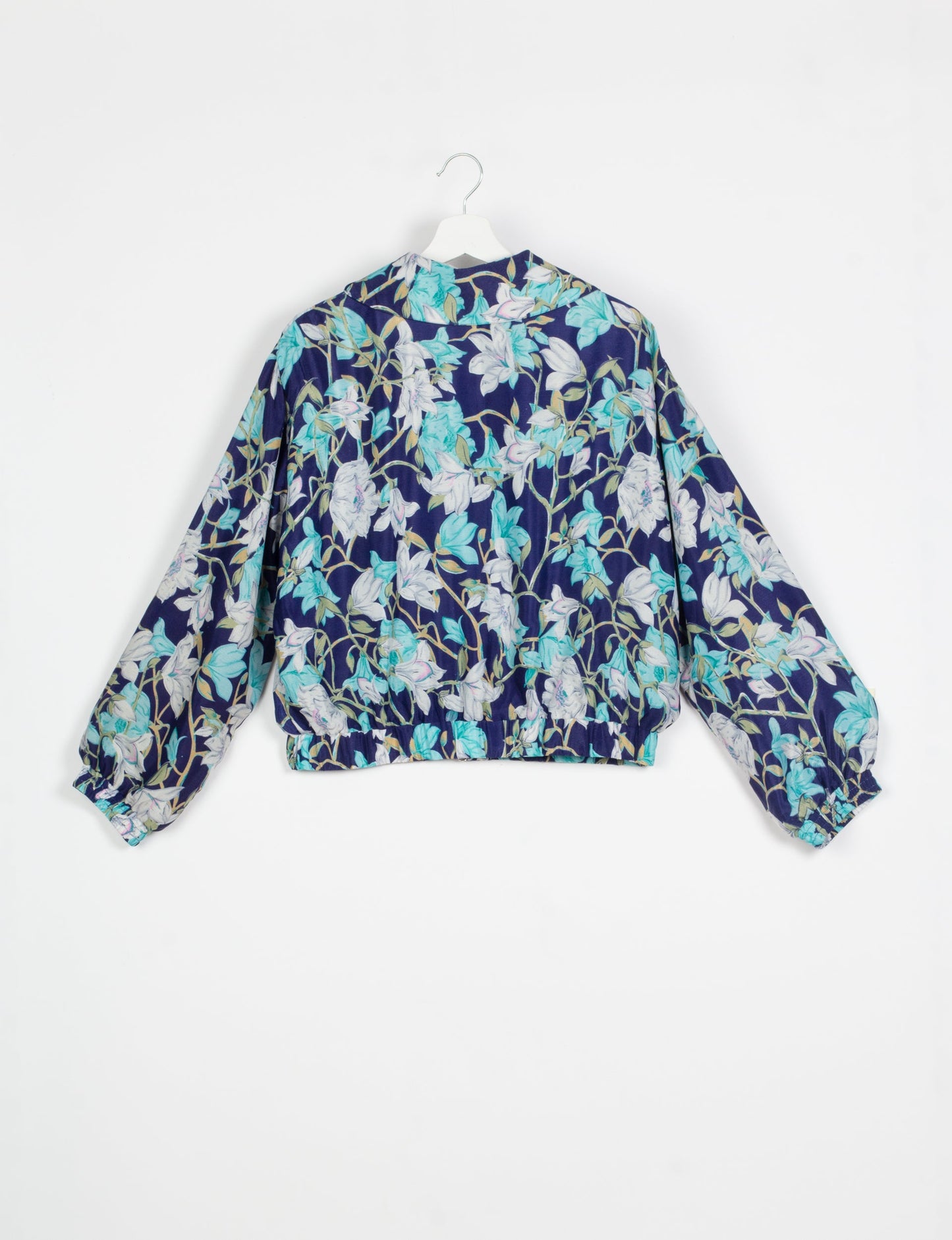 Stylish BOMBER JACKET, an upcycled clothing masterpiece with a cute cropped shape, elasticated details, and detachable metallic zipper. Contrast sari print lining adds a unique touch. Explore sustainable and eco-friendly fashion.