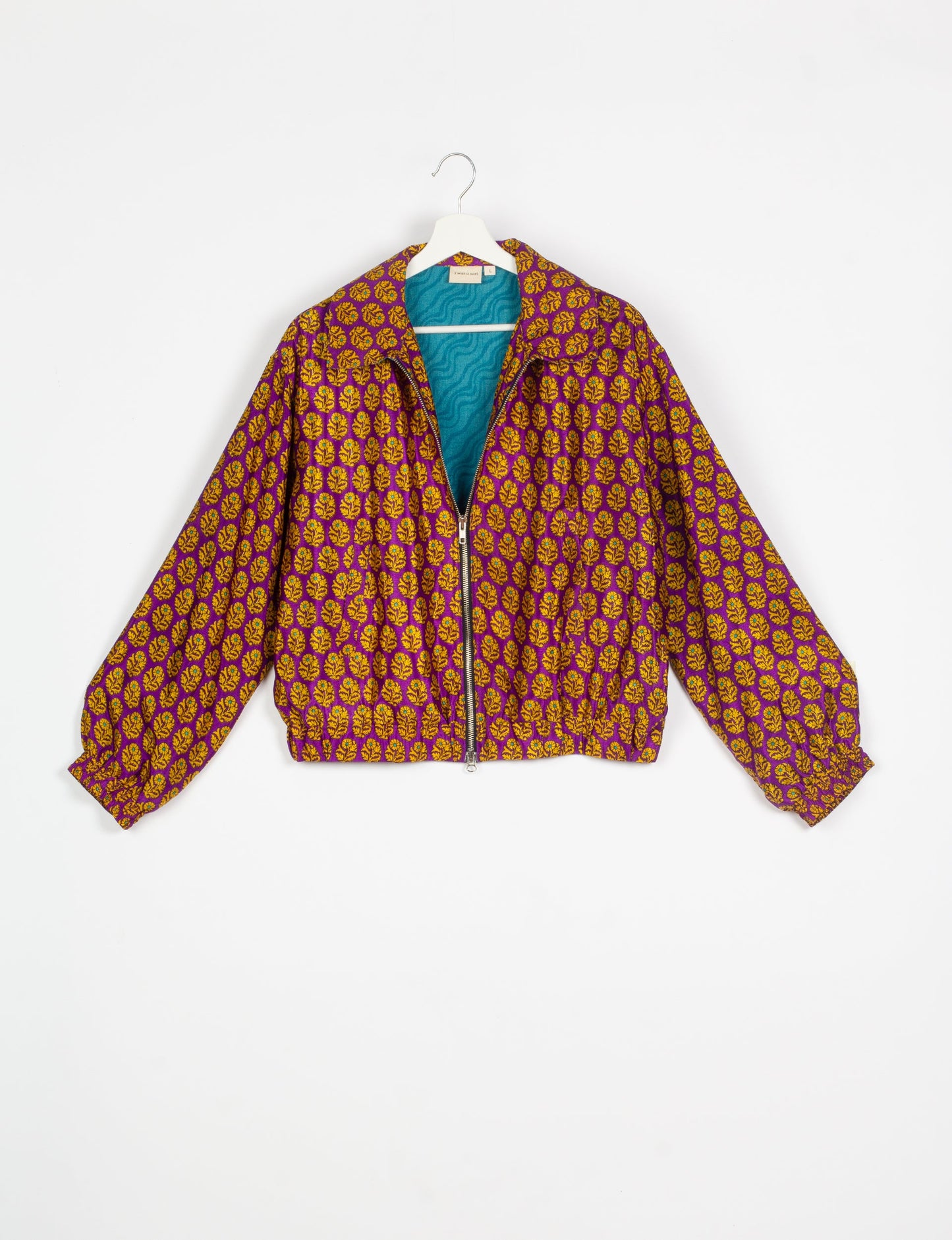 Stylish BOMBER JACKET, an upcycled clothing masterpiece with a cute cropped shape, elasticated details, and detachable metallic zipper. Contrast sari print lining adds a unique touch. Explore sustainable and eco-friendly fashion.