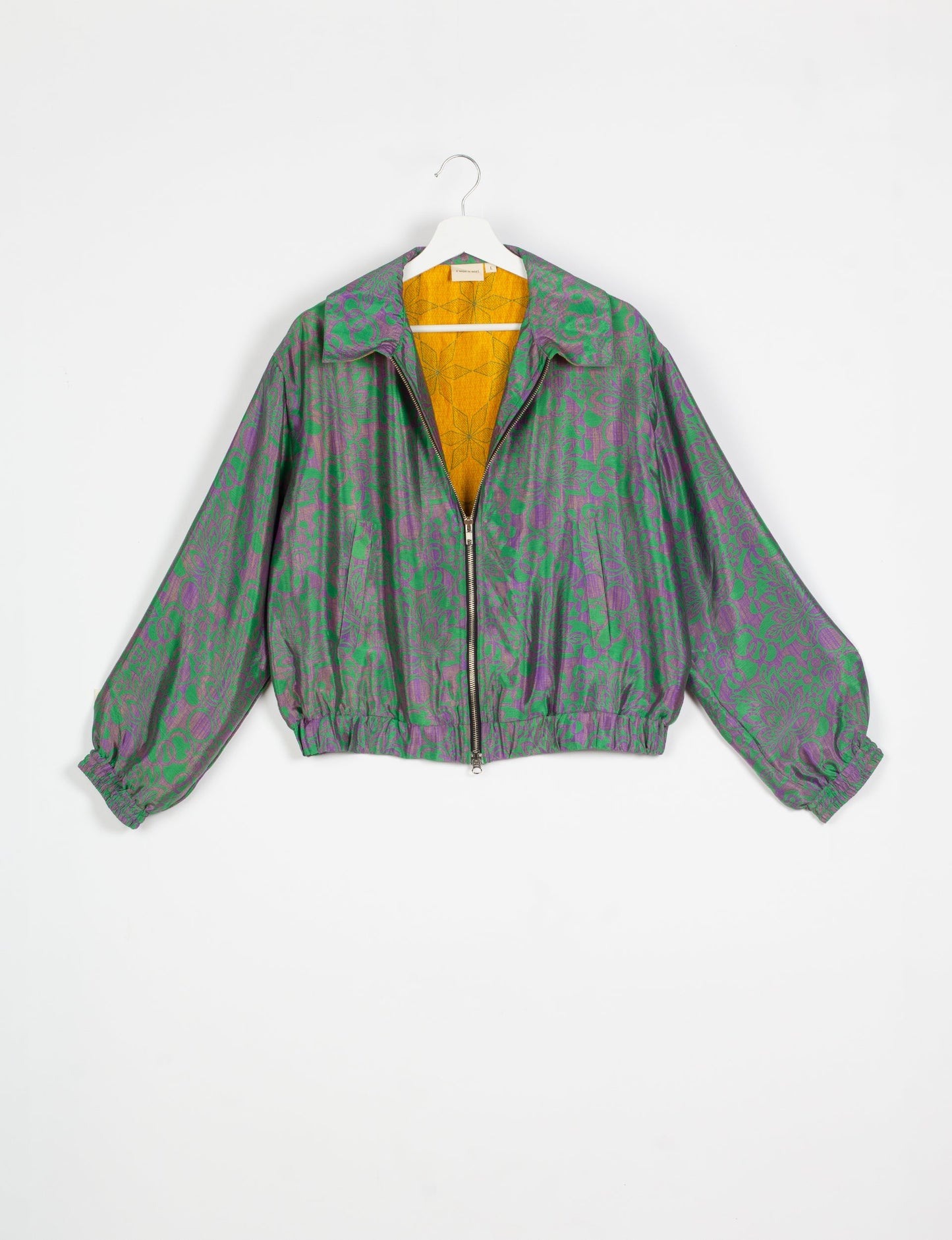 Stylish BOMBER JACKET, an upcycled clothing masterpiece with a cute cropped shape, elasticated details, and detachable metallic zipper. Contrast sari print lining adds a unique touch. Explore sustainable and eco-friendly fashion.