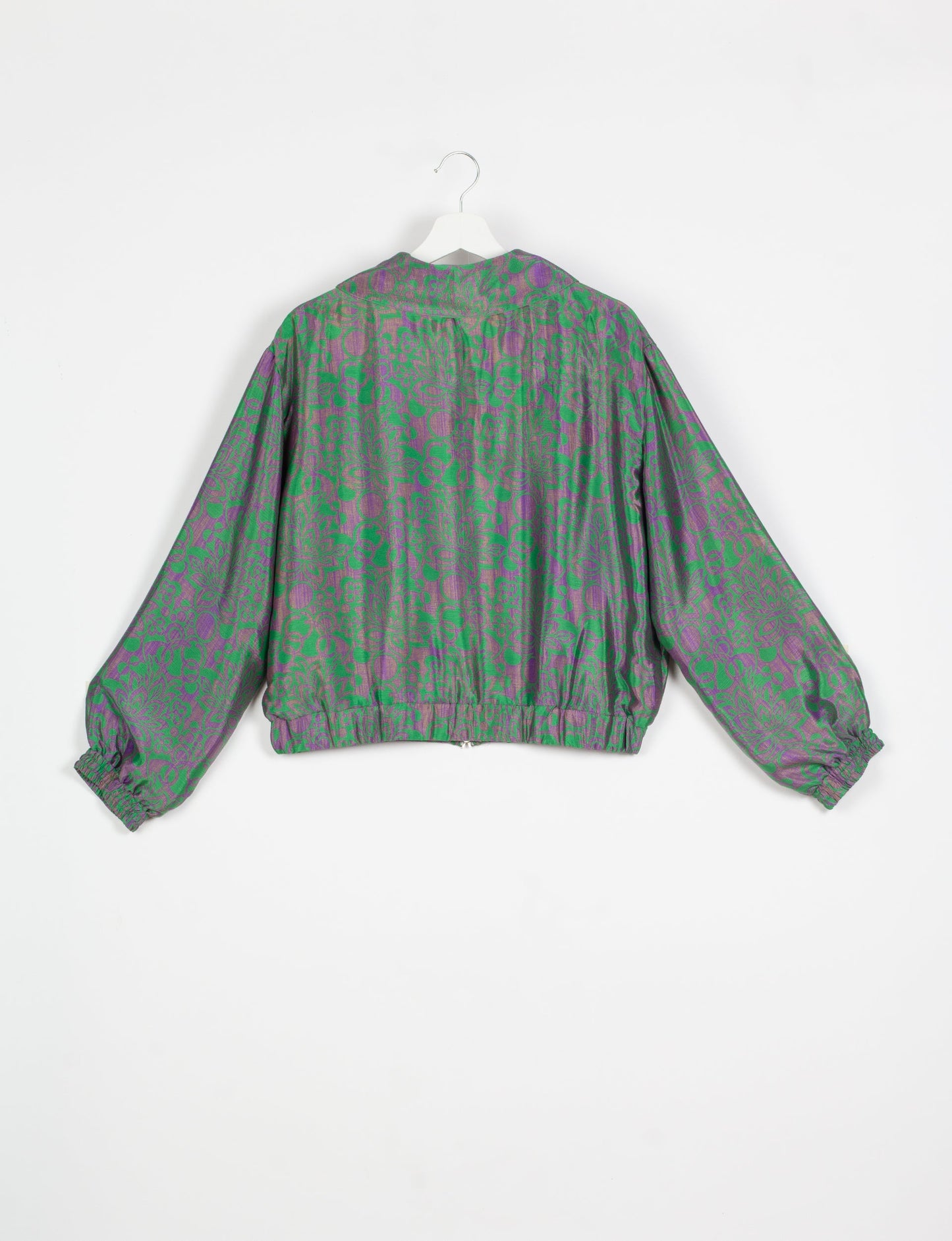 Stylish BOMBER JACKET, an upcycled clothing masterpiece with a cute cropped shape, elasticated details, and detachable metallic zipper. Contrast sari print lining adds a unique touch. Explore sustainable and eco-friendly fashion.