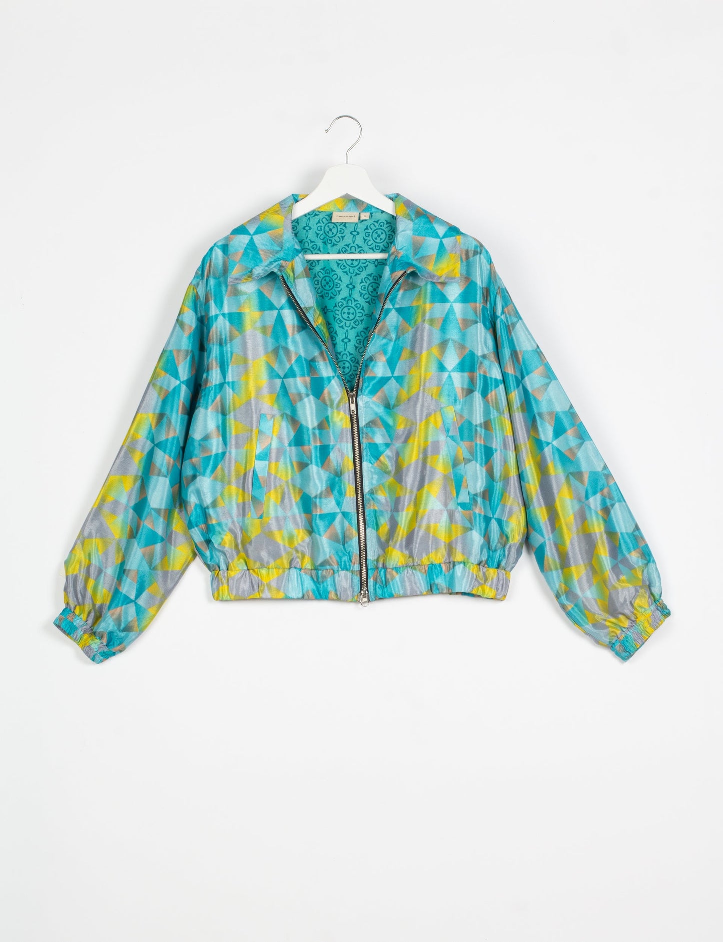 Stylish BOMBER JACKET, an upcycled clothing masterpiece with a cute cropped shape, elasticated details, and detachable metallic zipper. Contrast sari print lining adds a unique touch. Explore sustainable and eco-friendly fashion.