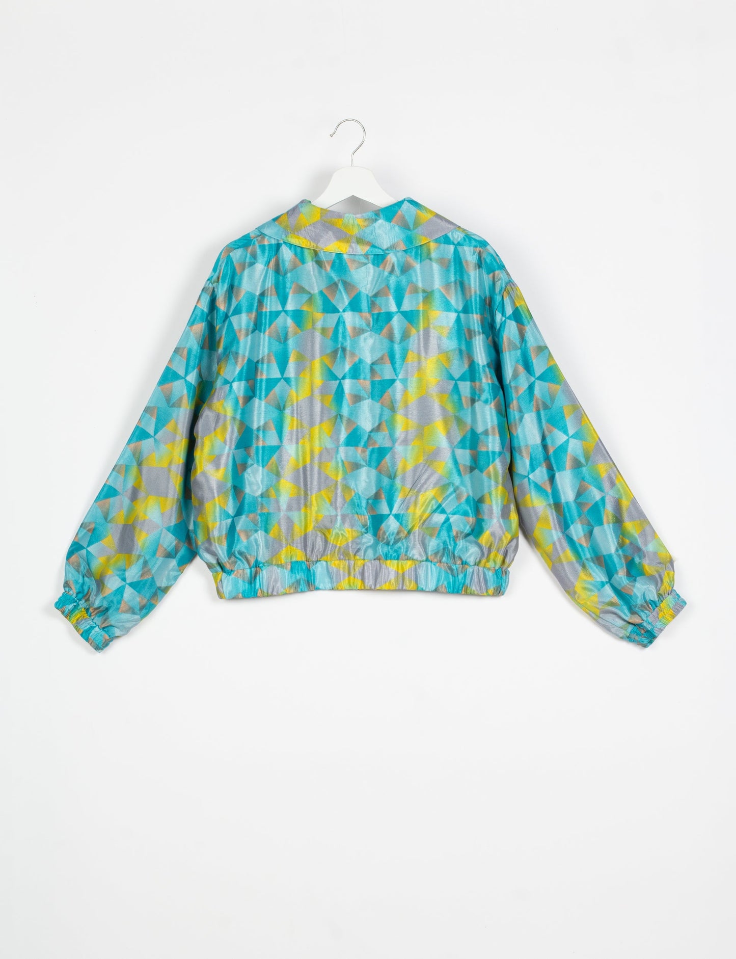 Stylish BOMBER JACKET, an upcycled clothing masterpiece with a cute cropped shape, elasticated details, and detachable metallic zipper. Contrast sari print lining adds a unique touch. Explore sustainable and eco-friendly fashion.