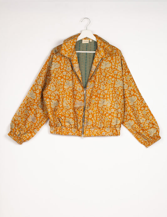 Stylish BOMBER JACKET, an upcycled clothing masterpiece with a cute cropped shape, elasticated details, and detachable metallic zipper. Contrast sari print lining adds a unique touch. Explore sustainable and eco-friendly fashion.