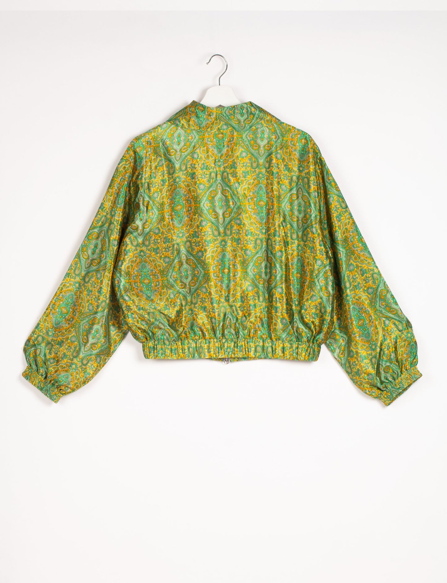 Stylish BOMBER JACKET, an upcycled clothing masterpiece with a cute cropped shape, elasticated details, and detachable metallic zipper. Contrast sari print lining adds a unique touch. Explore sustainable and eco-friendly fashion.