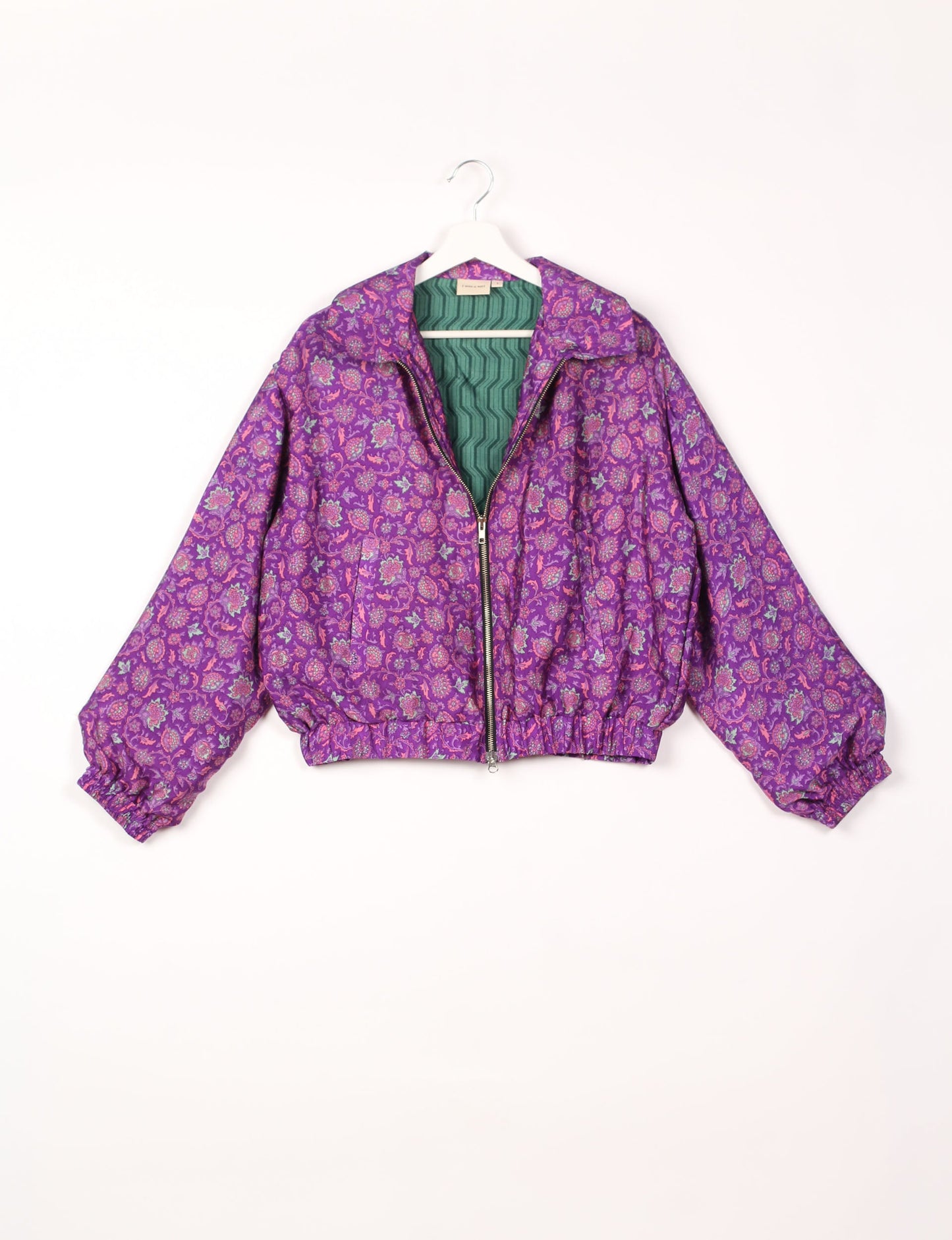 Stylish BOMBER JACKET, an upcycled clothing masterpiece with a cute cropped shape, elasticated details, and detachable metallic zipper. Contrast sari print lining adds a unique touch. Explore sustainable and eco-friendly fashion.