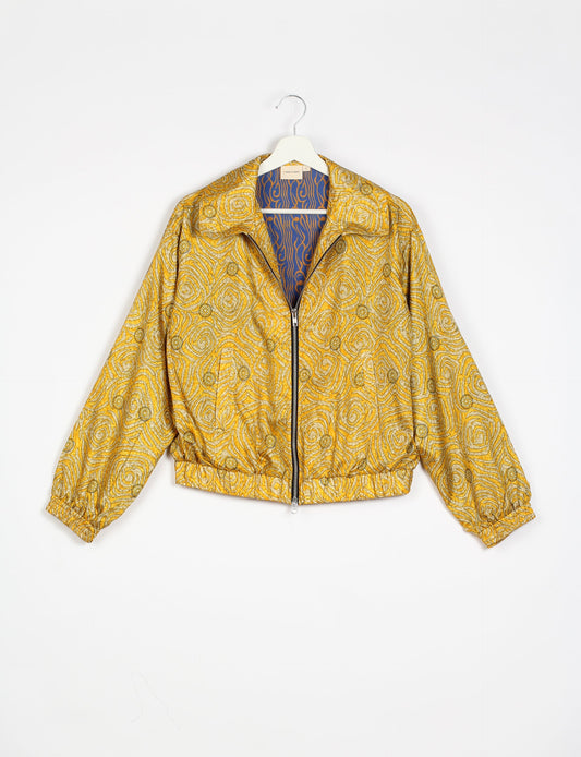 Stylish BOMBER JACKET, an upcycled clothing masterpiece with a cute cropped shape, elasticated details, and detachable metallic zipper. Contrast sari print lining adds a unique touch. Explore sustainable and eco-friendly fashion.