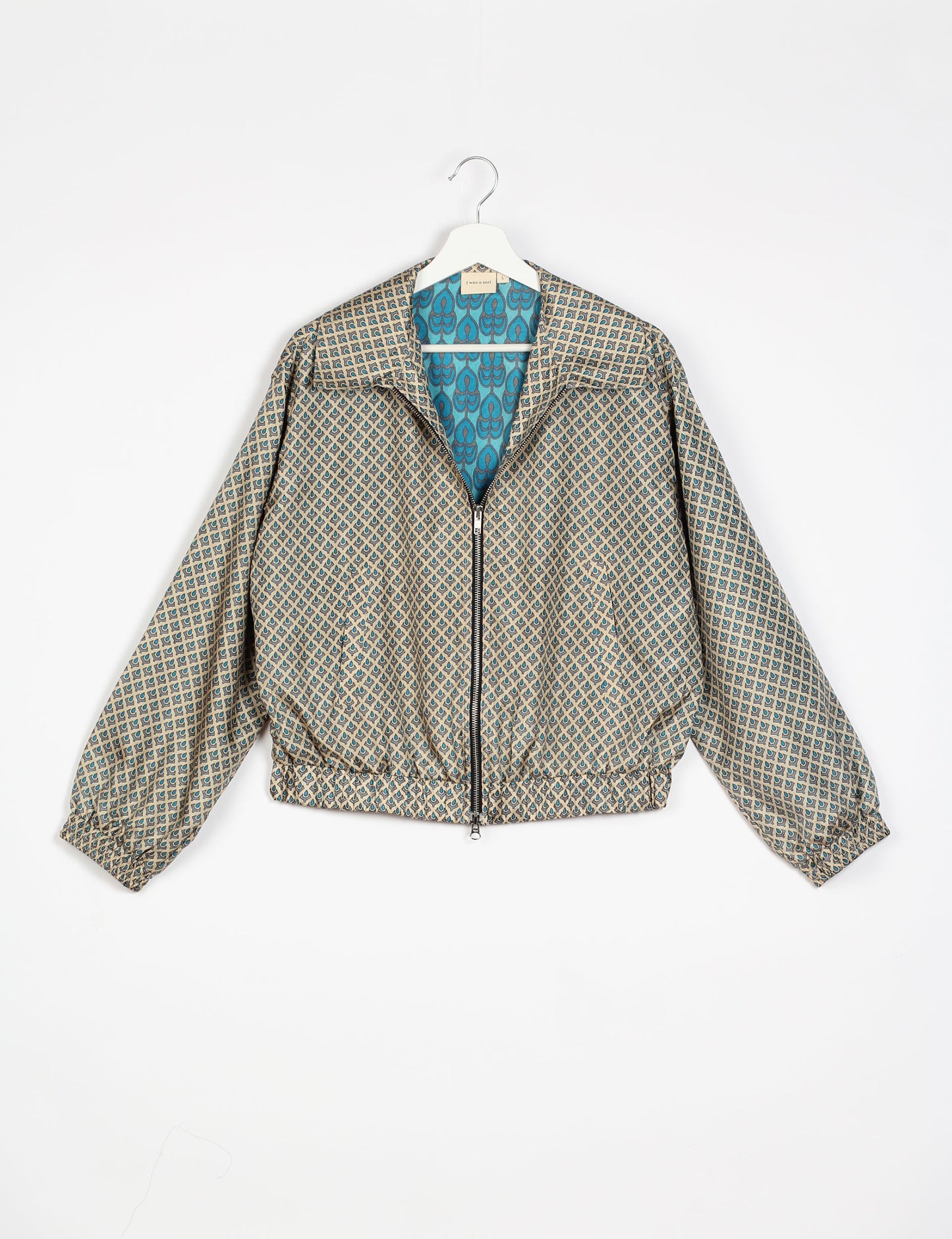 Stylish BOMBER JACKET, an upcycled clothing masterpiece with a cute cropped shape, elasticated details, and detachable metallic zipper. Contrast sari print lining adds a unique touch. Explore sustainable and eco-friendly fashion.