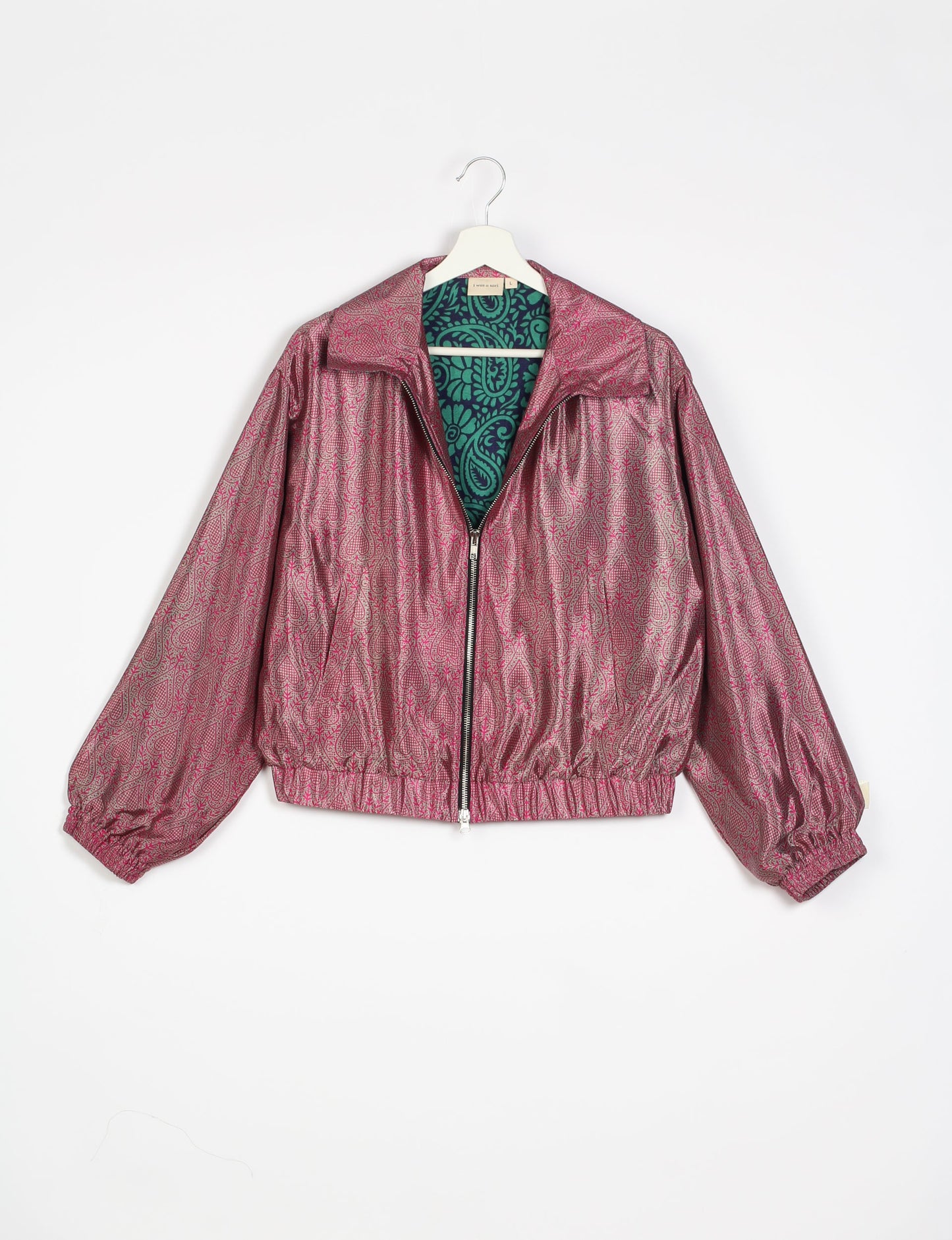 Stylish BOMBER JACKET, an upcycled clothing masterpiece with a cute cropped shape, elasticated details, and detachable metallic zipper. Contrast sari print lining adds a unique touch. Explore sustainable and eco-friendly fashion.