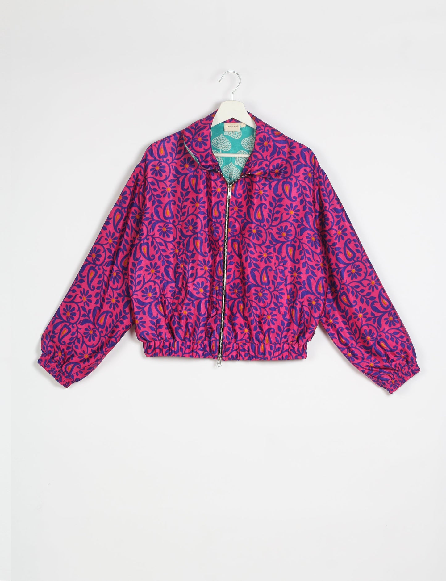 Stylish BOMBER JACKET, an upcycled clothing masterpiece with a cute cropped shape, elasticated details, and detachable metallic zipper. Contrast sari print lining adds a unique touch. Explore sustainable and eco-friendly fashion.