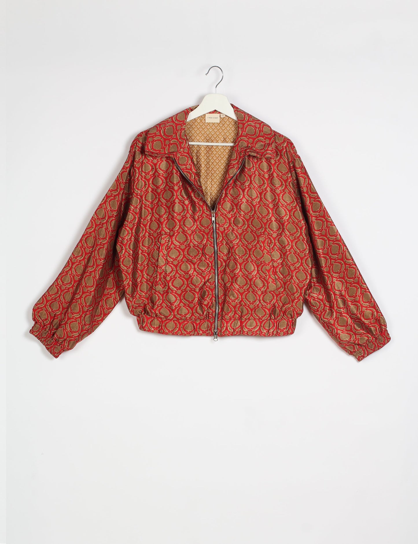 Stylish BOMBER JACKET, an upcycled clothing masterpiece with a cute cropped shape, elasticated details, and detachable metallic zipper. Contrast sari print lining adds a unique touch. Explore sustainable and eco-friendly fashion.