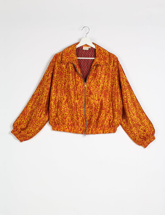 Stylish BOMBER JACKET, an upcycled clothing masterpiece with a cute cropped shape, elasticated details, and detachable metallic zipper. Contrast sari print lining adds a unique touch. Explore sustainable and eco-friendly fashion.