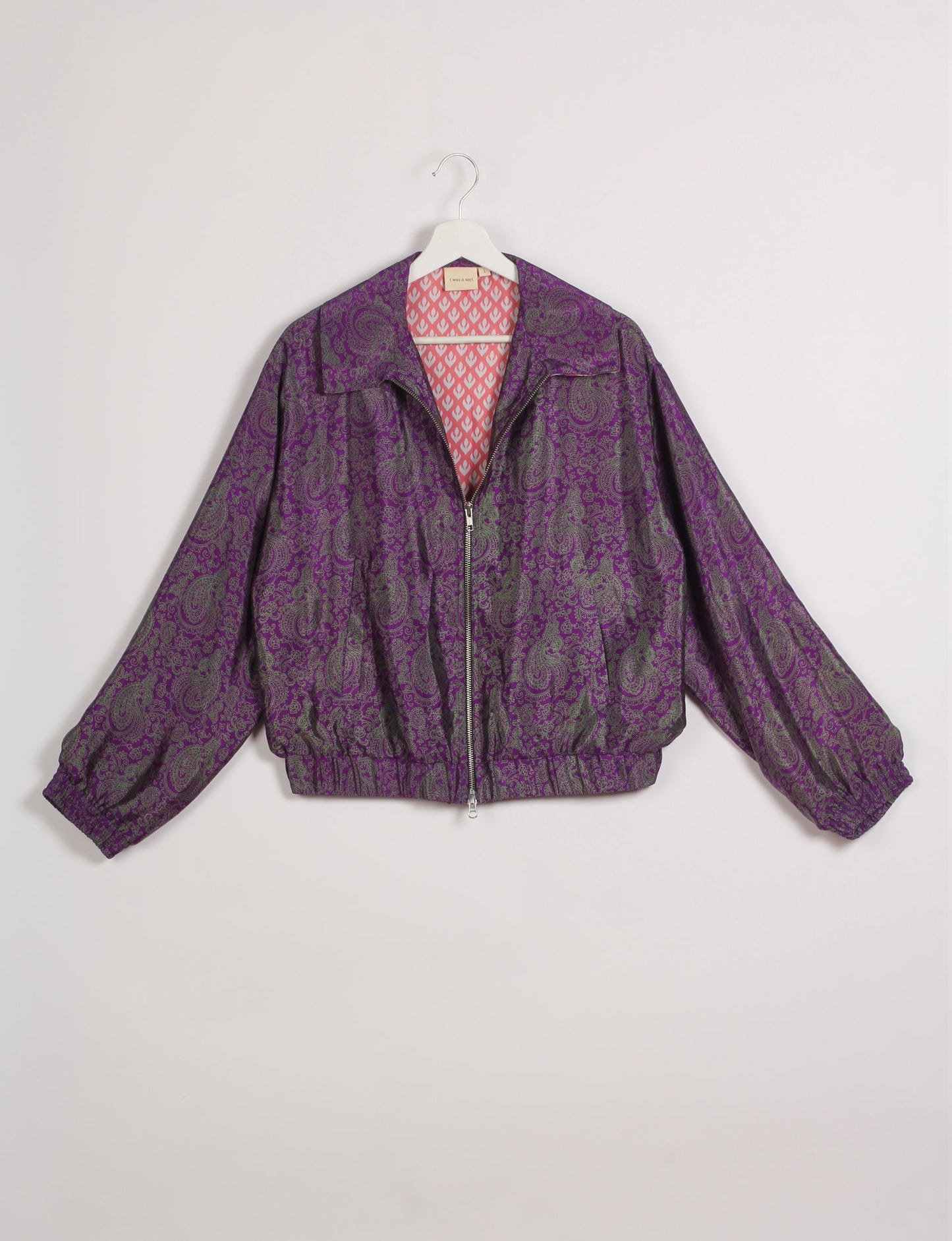 Stylish BOMBER JACKET, an upcycled clothing masterpiece with a cute cropped shape, elasticated details, and detachable metallic zipper. Contrast sari print lining adds a unique touch. Explore sustainable and eco-friendly fashion.