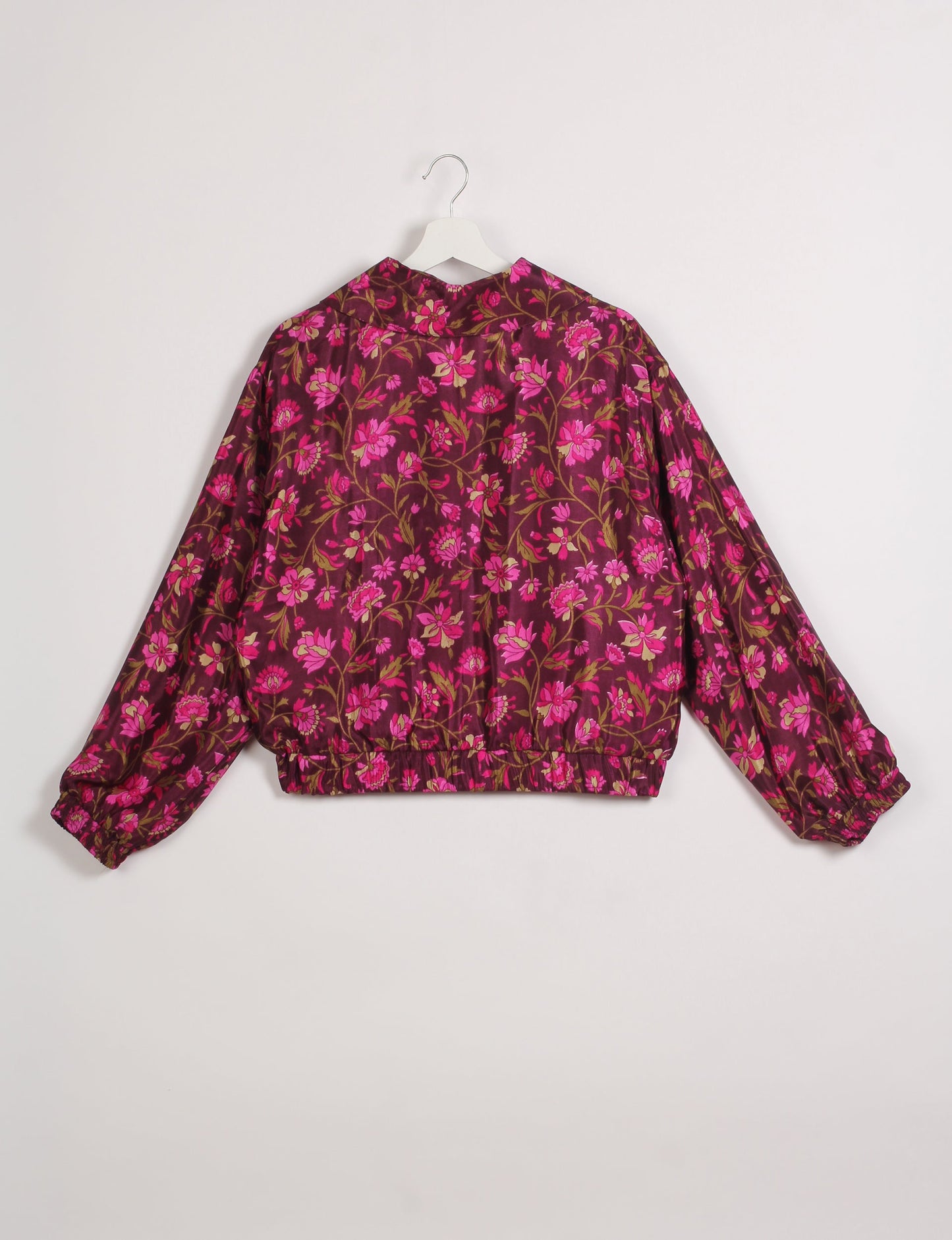 Stylish BOMBER JACKET, an upcycled clothing masterpiece with a cute cropped shape, elasticated details, and detachable metallic zipper. Contrast sari print lining adds a unique touch. Explore sustainable and eco-friendly fashion.