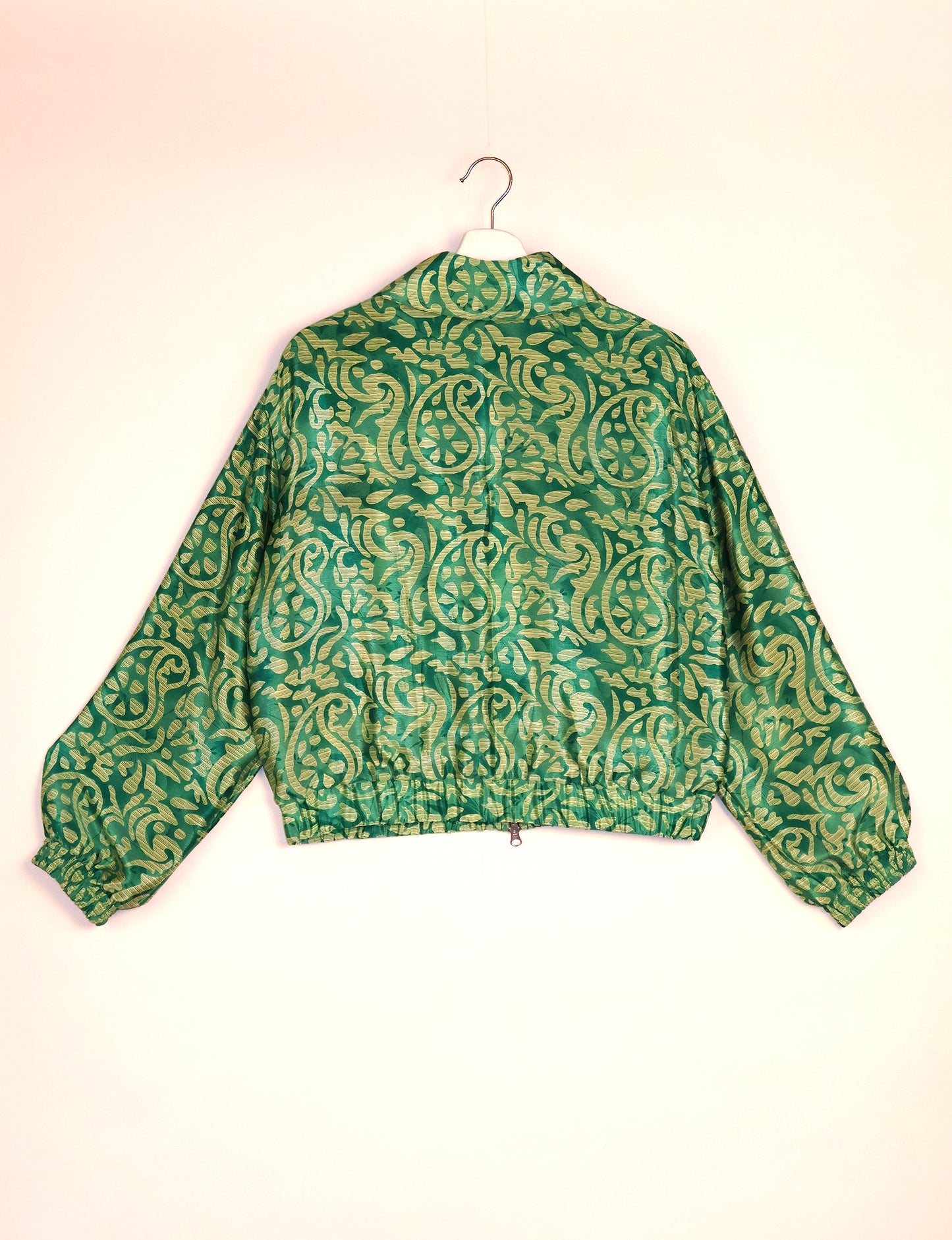 Stylish BOMBER JACKET, an upcycled clothing masterpiece with a cute cropped shape, elasticated details, and detachable metallic zipper. Contrast sari print lining adds a unique touch. Explore sustainable and eco-friendly fashion.