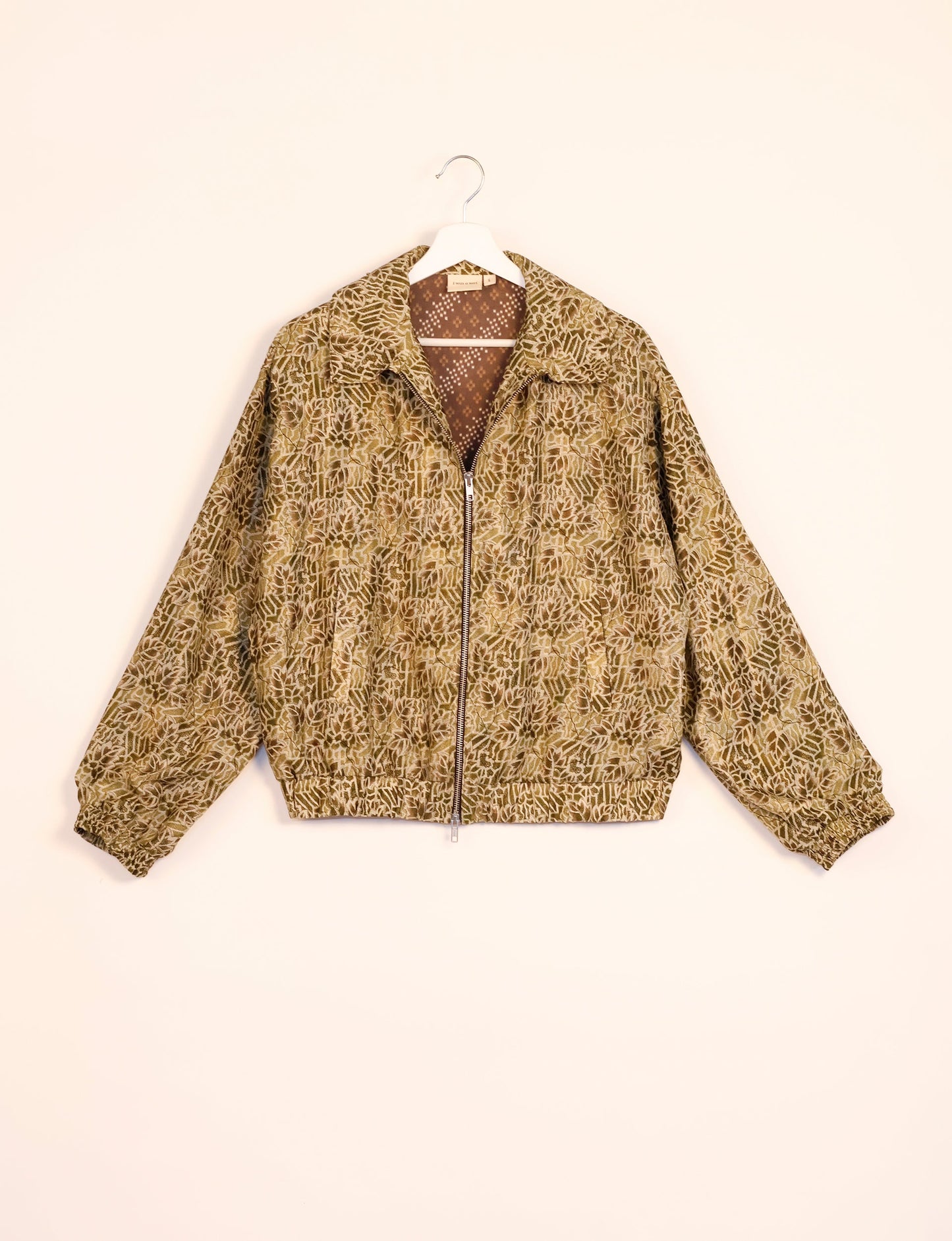 Stylish BOMBER JACKET, an upcycled clothing masterpiece with a cute cropped shape, elasticated details, and detachable metallic zipper. Contrast sari print lining adds a unique touch. Explore sustainable and eco-friendly fashion.