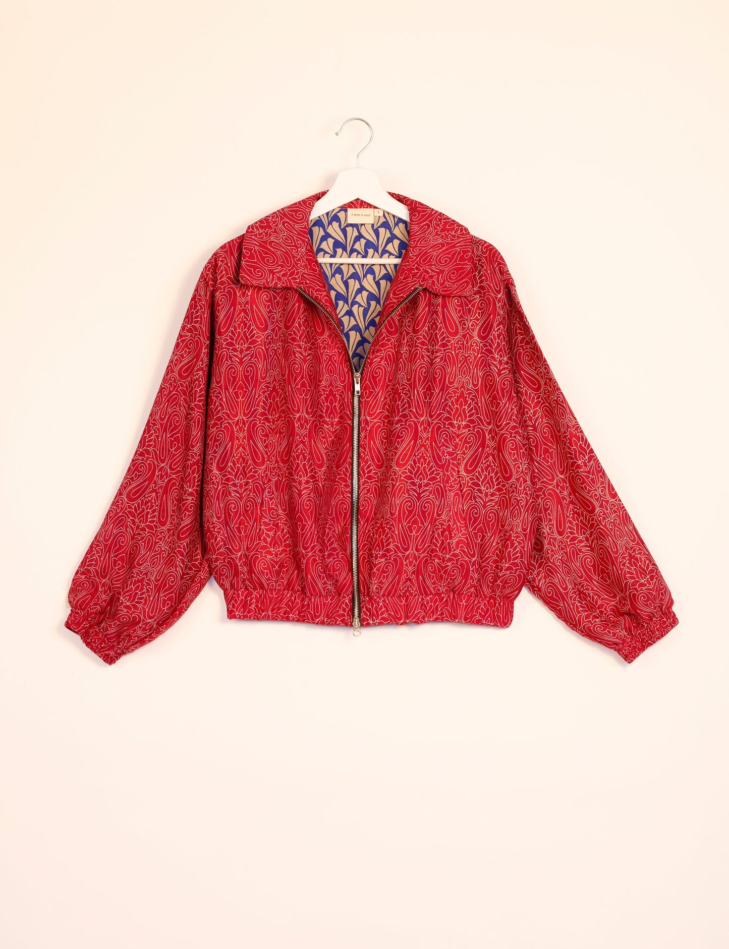 Stylish BOMBER JACKET, an upcycled clothing masterpiece with a cute cropped shape, elasticated details, and detachable metallic zipper. Contrast sari print lining adds a unique touch. Explore sustainable and eco-friendly fashion.