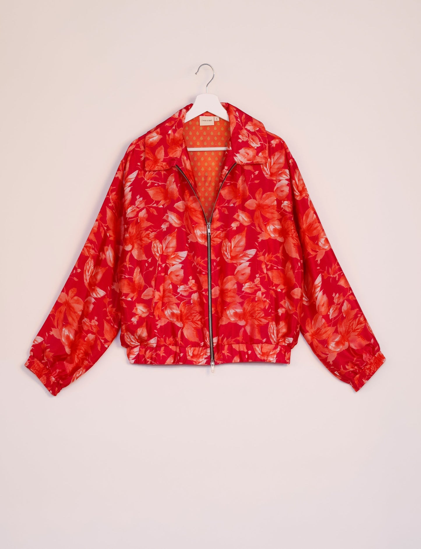 Stylish BOMBER JACKET, an upcycled clothing masterpiece with a cute cropped shape, elasticated details, and detachable metallic zipper. Contrast sari print lining adds a unique touch. Explore sustainable and eco-friendly fashion.