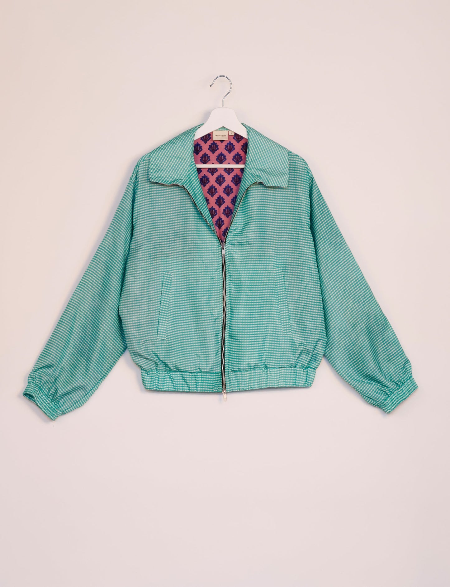 Stylish BOMBER JACKET, an upcycled clothing masterpiece with a cute cropped shape, elasticated details, and detachable metallic zipper. Contrast sari print lining adds a unique touch. Explore sustainable and eco-friendly fashion.