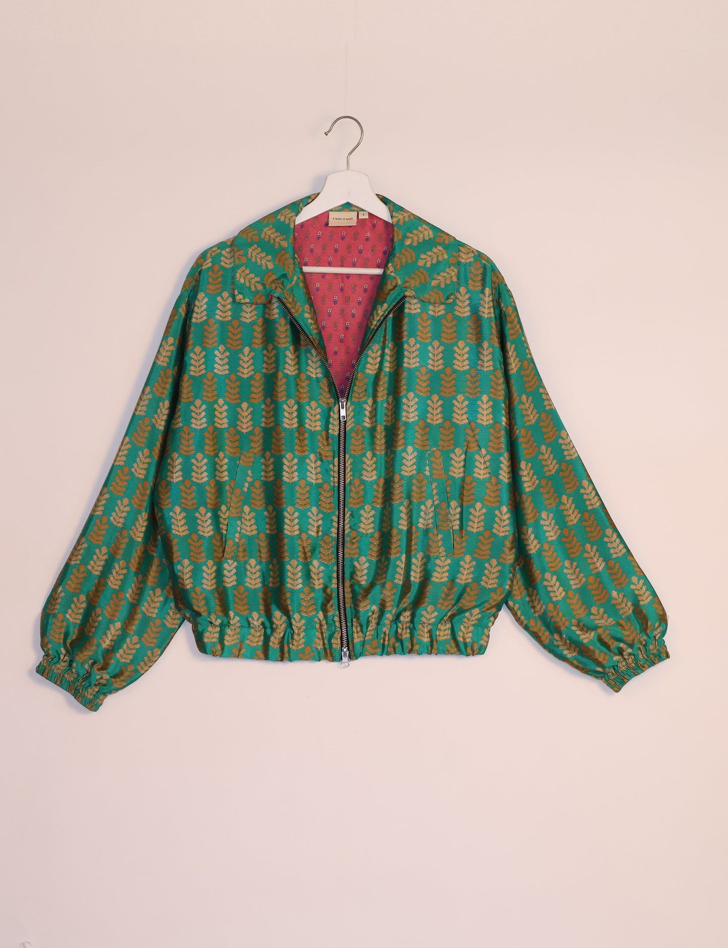 Stylish BOMBER JACKET, an upcycled clothing masterpiece with a cute cropped shape, elasticated details, and detachable metallic zipper. Contrast sari print lining adds a unique touch. Explore sustainable and eco-friendly fashion.