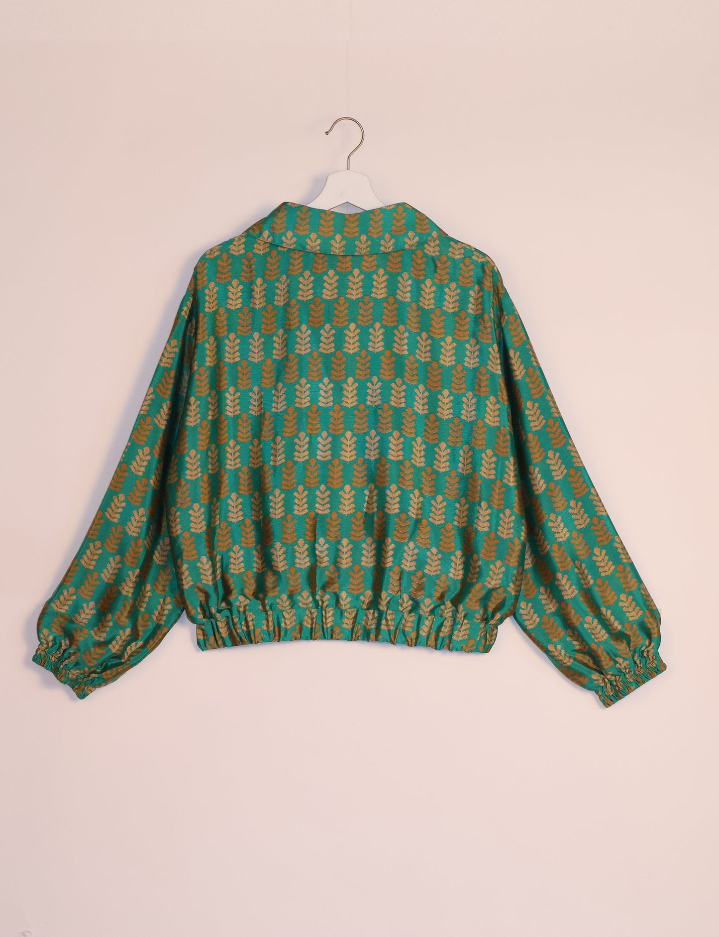 Stylish BOMBER JACKET, an upcycled clothing masterpiece with a cute cropped shape, elasticated details, and detachable metallic zipper. Contrast sari print lining adds a unique touch. Explore sustainable and eco-friendly fashion.