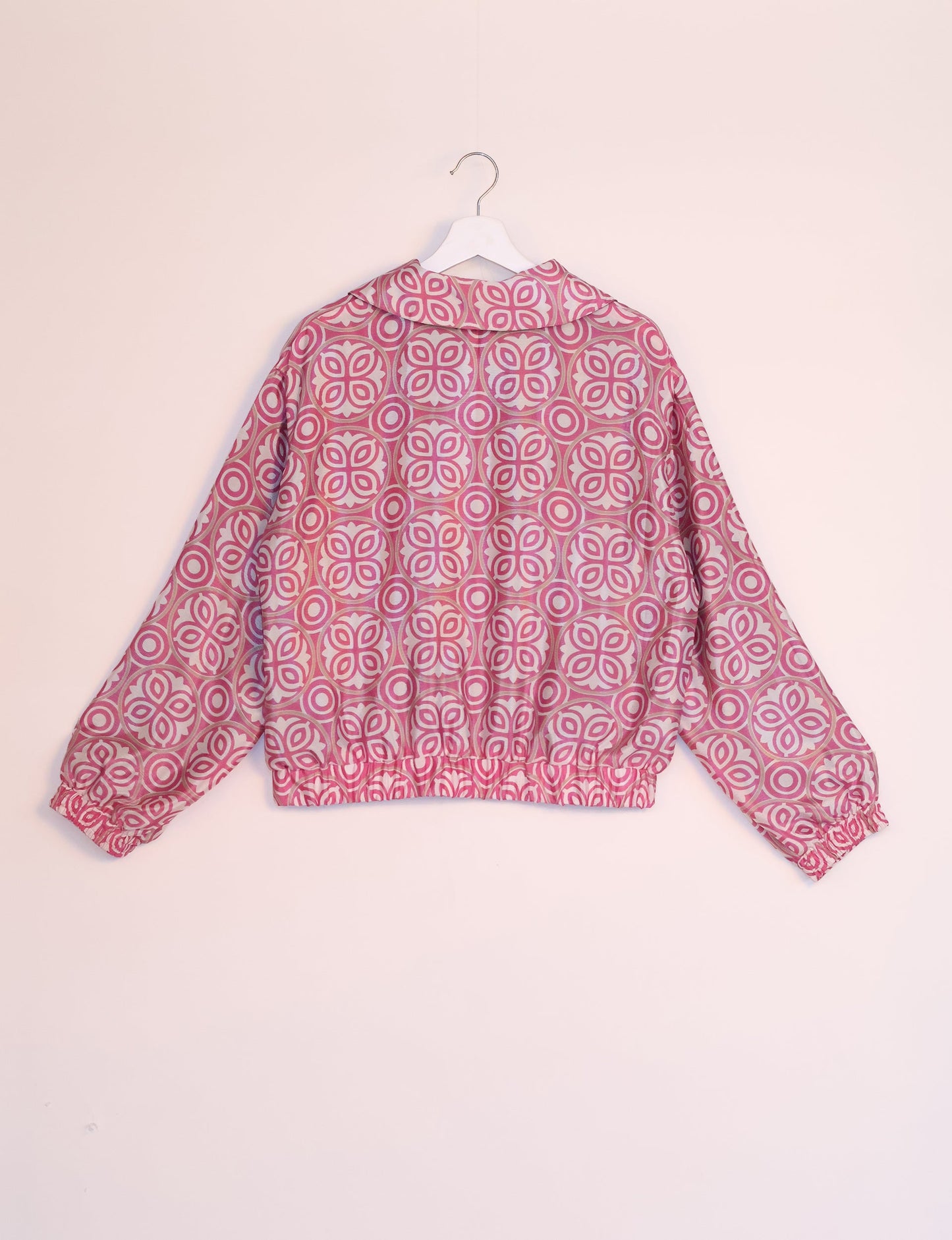 Stylish BOMBER JACKET, an upcycled clothing masterpiece with a cute cropped shape, elasticated details, and detachable metallic zipper. Contrast sari print lining adds a unique touch. Explore sustainable and eco-friendly fashion.