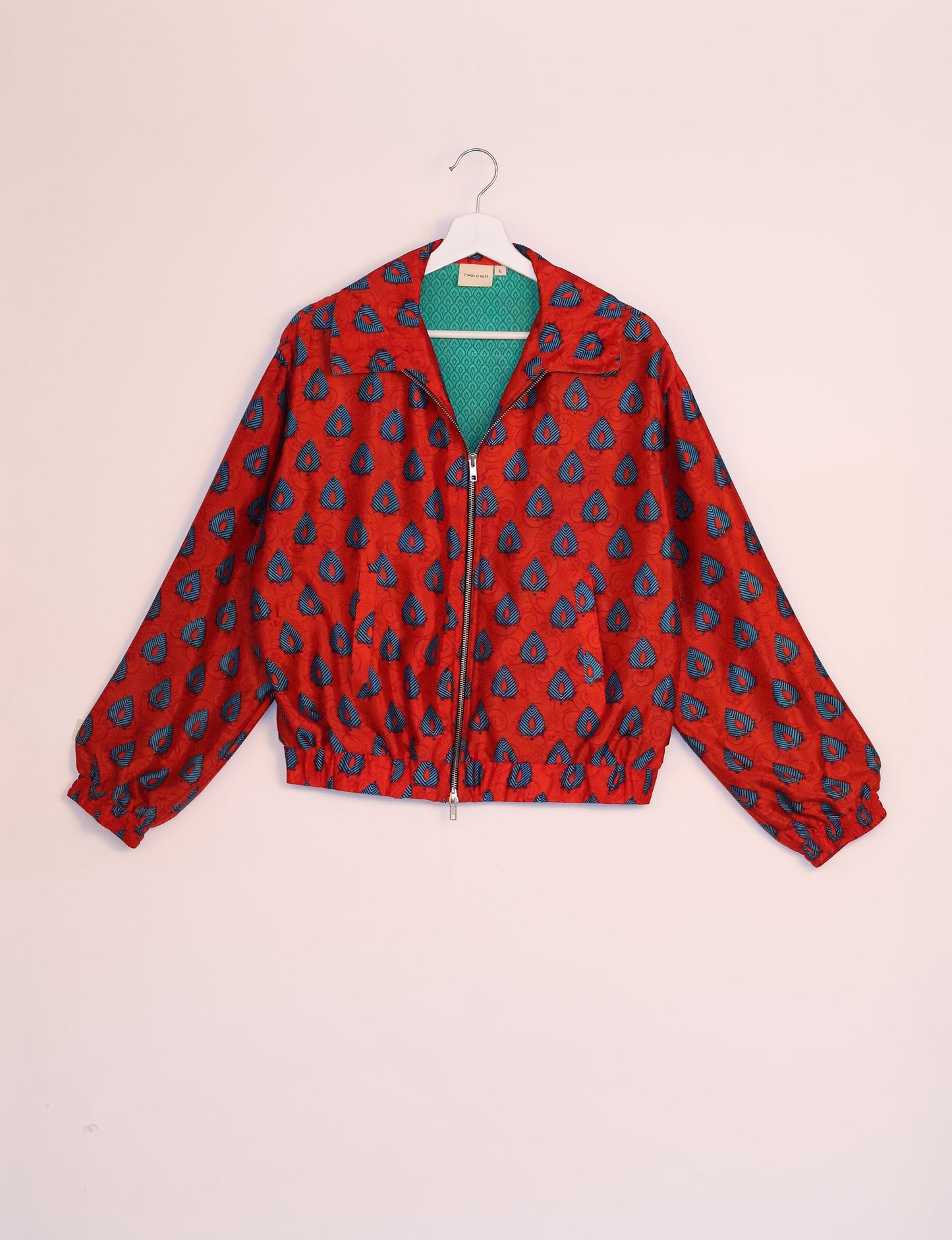 Stylish BOMBER JACKET, an upcycled clothing masterpiece with a cute cropped shape, elasticated details, and detachable metallic zipper. Contrast sari print lining adds a unique touch. Explore sustainable and eco-friendly fashion.