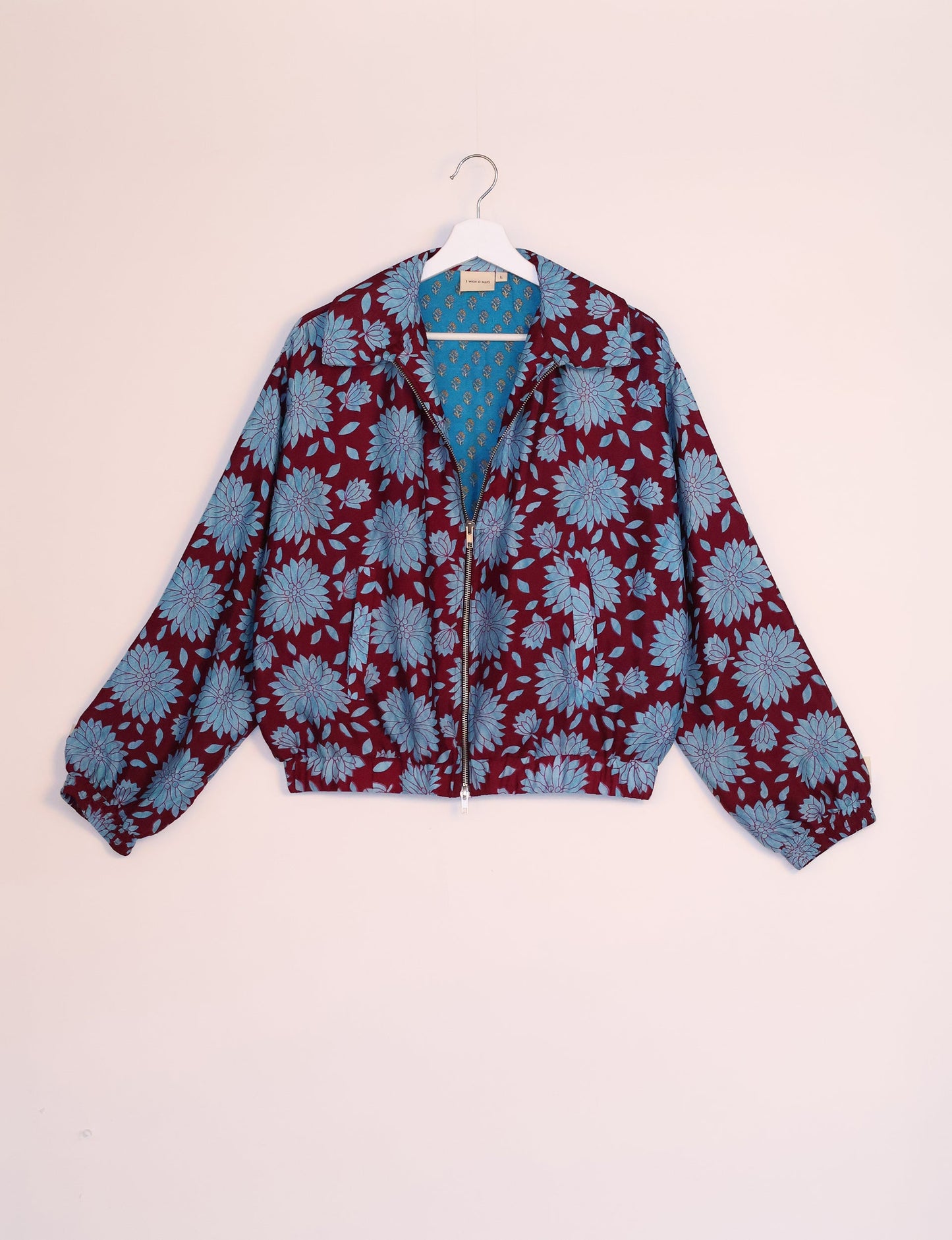 Stylish BOMBER JACKET, an upcycled clothing masterpiece with a cute cropped shape, elasticated details, and detachable metallic zipper. Contrast sari print lining adds a unique touch. Explore sustainable and eco-friendly fashion.