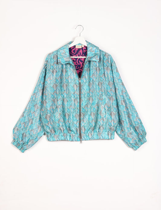 Stylish BOMBER JACKET, an upcycled clothing masterpiece with a cute cropped shape, elasticated details, and detachable metallic zipper. Contrast sari print lining adds a unique touch. Explore sustainable and eco-friendly fashion.