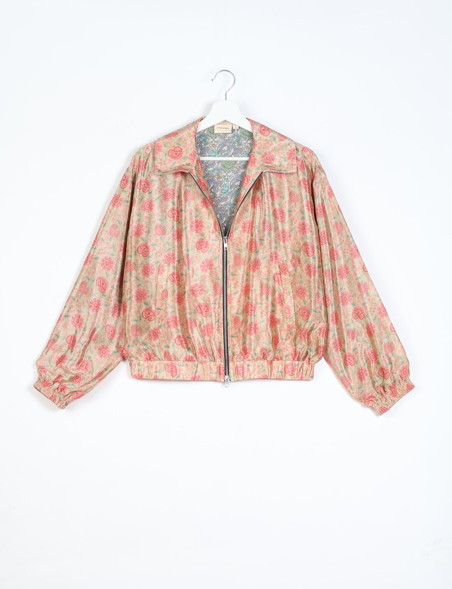 Stylish BOMBER JACKET, an upcycled clothing masterpiece with a cute cropped shape, elasticated details, and detachable metallic zipper. Contrast sari print lining adds a unique touch. Explore sustainable and eco-friendly fashion.