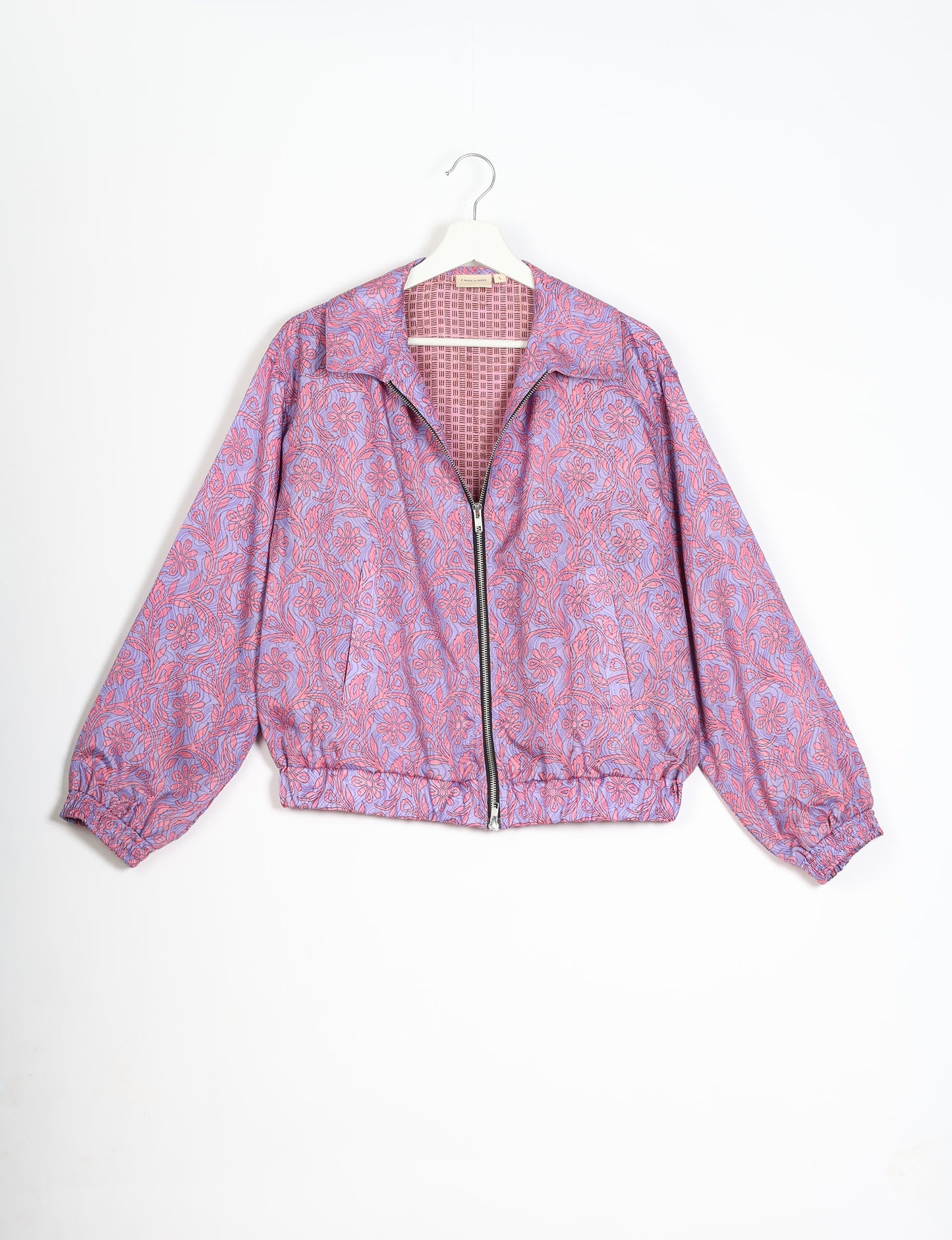 Stylish BOMBER JACKET, an upcycled clothing masterpiece with a cute cropped shape, elasticated details, and detachable metallic zipper. Contrast sari print lining adds a unique touch. Explore sustainable and eco-friendly fashion.