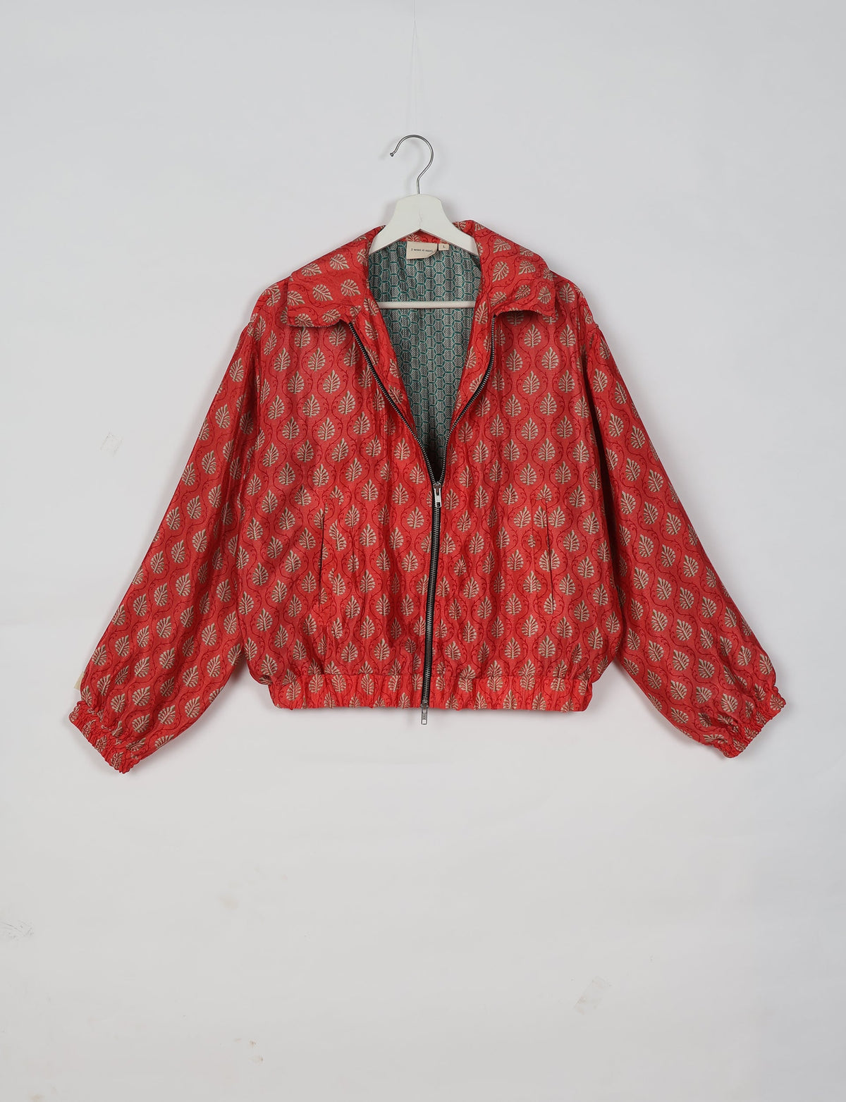 Stylish BOMBER JACKET, an upcycled clothing masterpiece with a cute cropped shape, elasticated details, and detachable metallic zipper. Contrast sari print lining adds a unique touch. Explore sustainable and eco-friendly fashion.