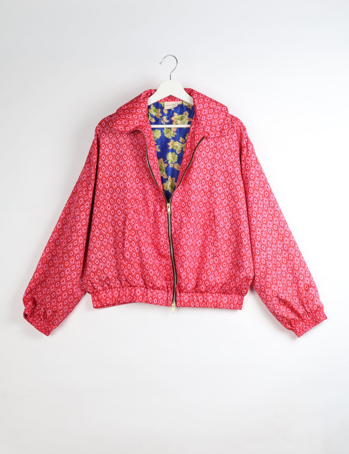 Upcycled Bomber Jacket made from recycled sari materials, featuring a cute cropped shape, elasticated hem and cuffs, and contrast sari print lining. Sustainable apparel promoting eco-friendly fashion and ethical clothing.