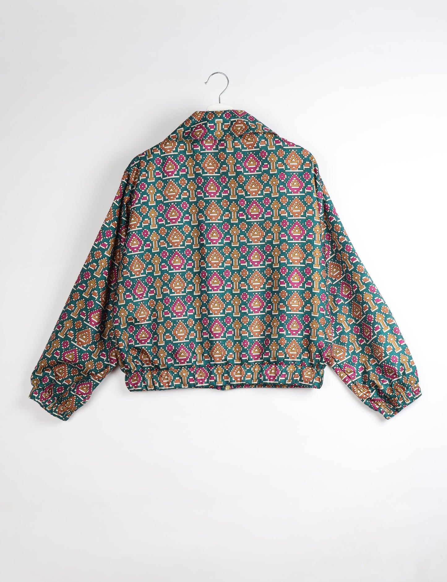 Upcycled Bomber Jacket made from recycled sari materials, featuring a cute cropped shape, elasticated hem and cuffs, and contrast sari print lining. Sustainable apparel promoting eco-friendly fashion and ethical clothing.