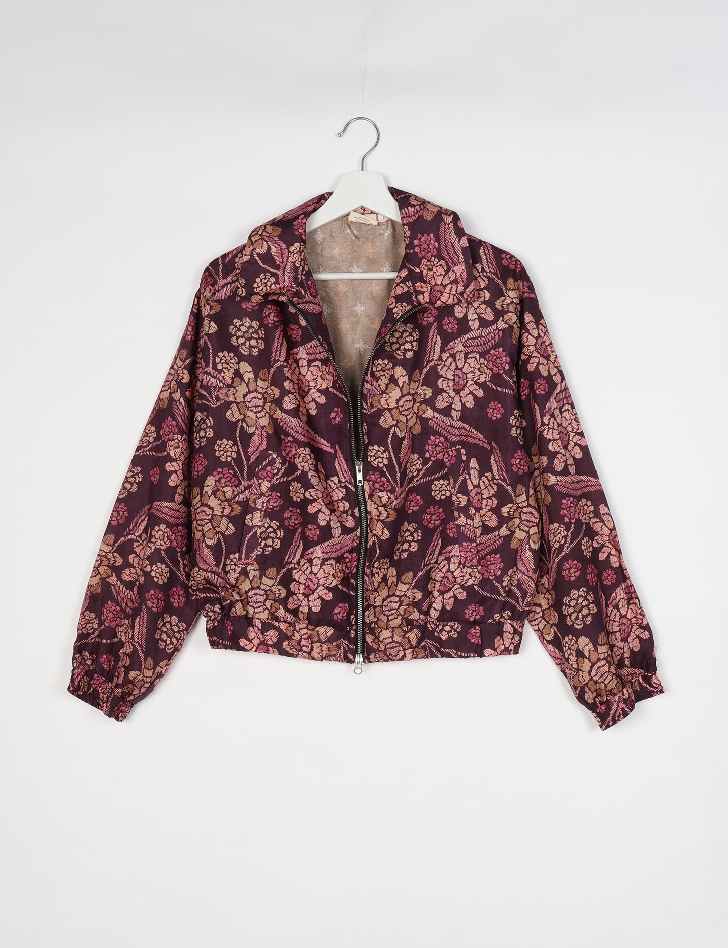 Upcycled Bomber Jacket made from recycled sari materials, featuring a cute cropped shape, elasticated hem and cuffs, and contrast sari print lining. Sustainable apparel promoting eco-friendly fashion and ethical clothing.