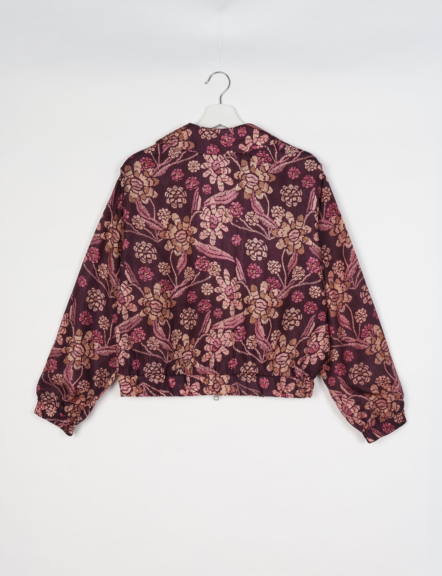 Upcycled Bomber Jacket made from recycled sari materials, featuring a cute cropped shape, elasticated hem and cuffs, and contrast sari print lining. Sustainable apparel promoting eco-friendly fashion and ethical clothing.