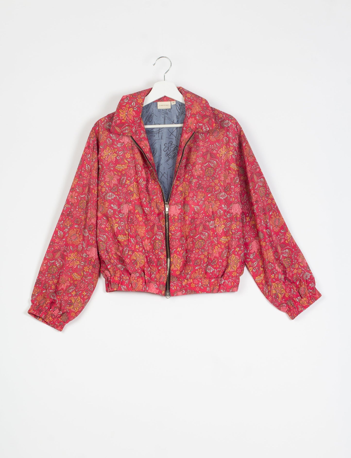 Stylish BOMBER JACKET, an upcycled clothing masterpiece with a cute cropped shape, elasticated details, and detachable metallic zipper. Contrast sari print lining adds a unique touch. Explore sustainable and eco-friendly fashion.