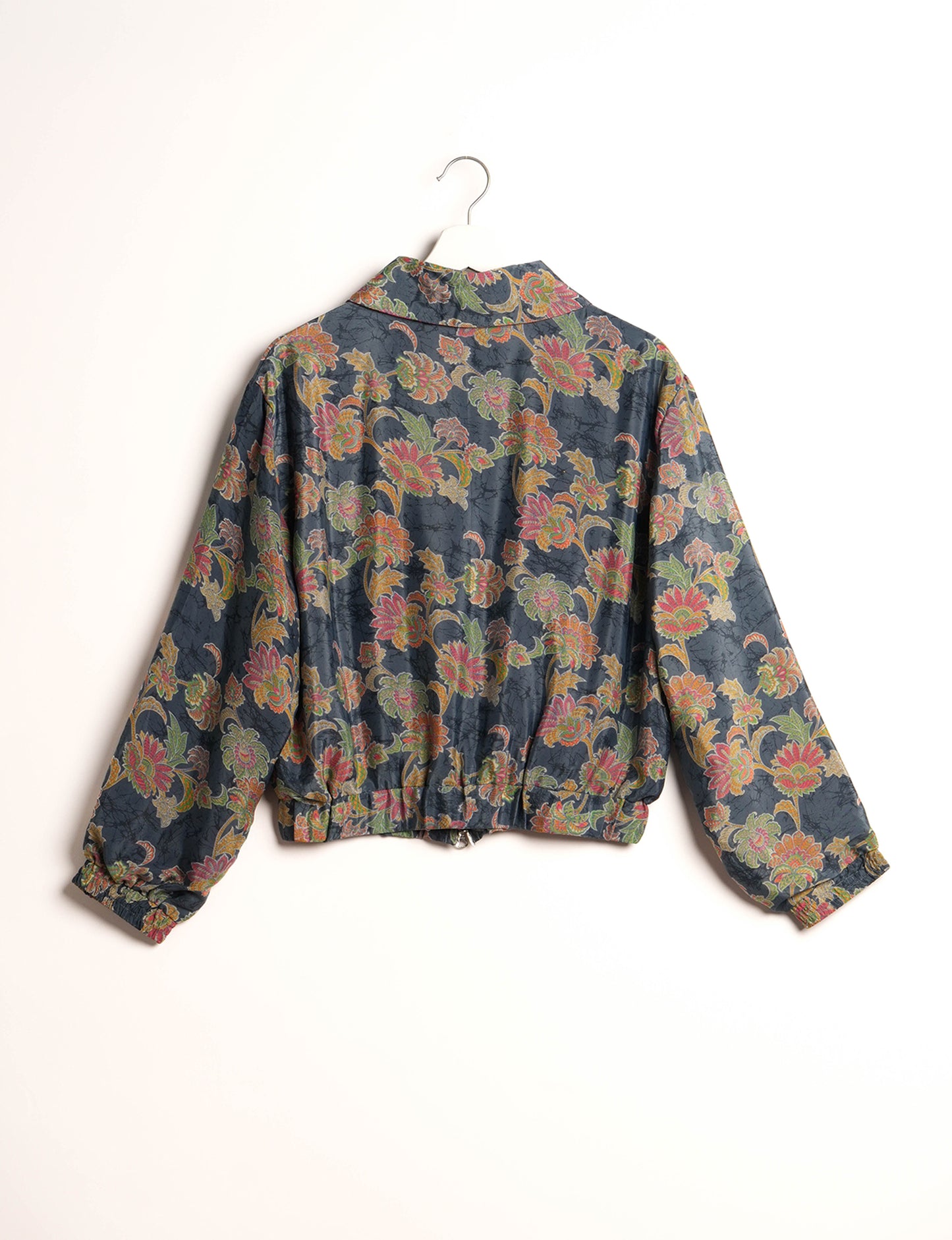 Stylish BOMBER JACKET, an upcycled clothing masterpiece with a cute cropped shape, elasticated details, and detachable metallic zipper. Contrast sari print lining adds a unique touch. Explore sustainable and eco-friendly fashion.