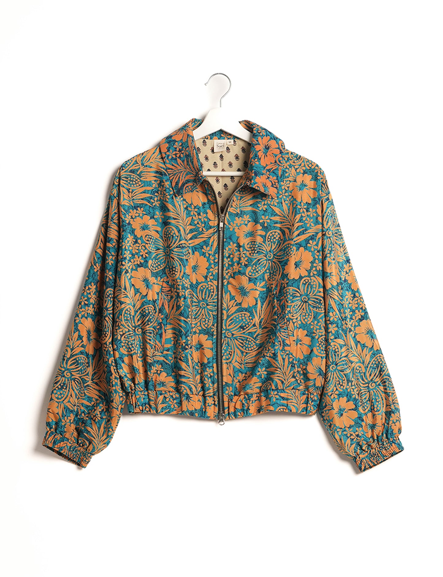 Stylish BOMBER JACKET, an upcycled clothing masterpiece with a cute cropped shape, elasticated details, and detachable metallic zipper. Contrast sari print lining adds a unique touch. Explore sustainable and eco-friendly fashion.