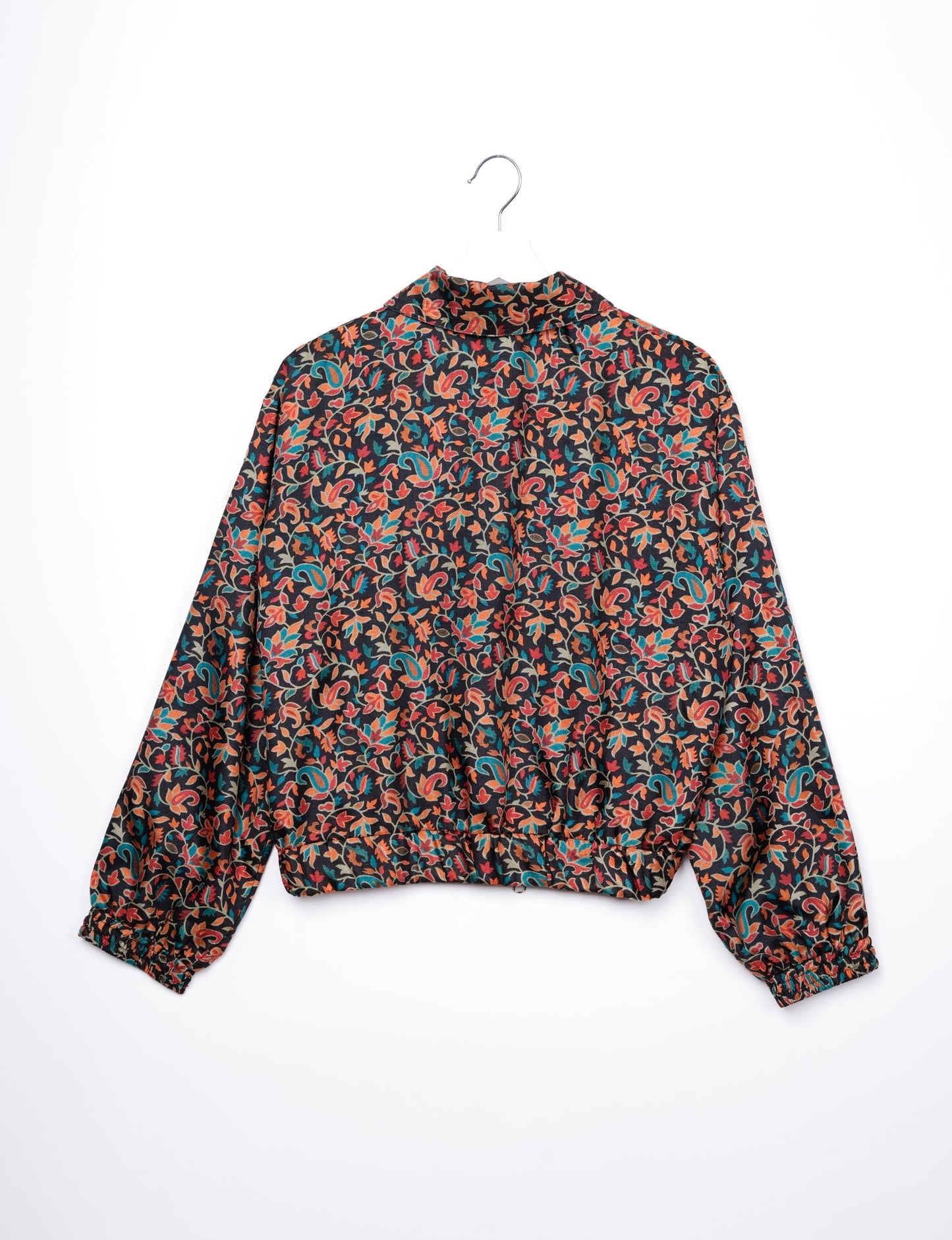 Stylish BOMBER JACKET, an upcycled clothing masterpiece with a cute cropped shape, elasticated details, and detachable metallic zipper. Contrast sari print lining adds a unique touch. Explore sustainable and eco-friendly fashion.