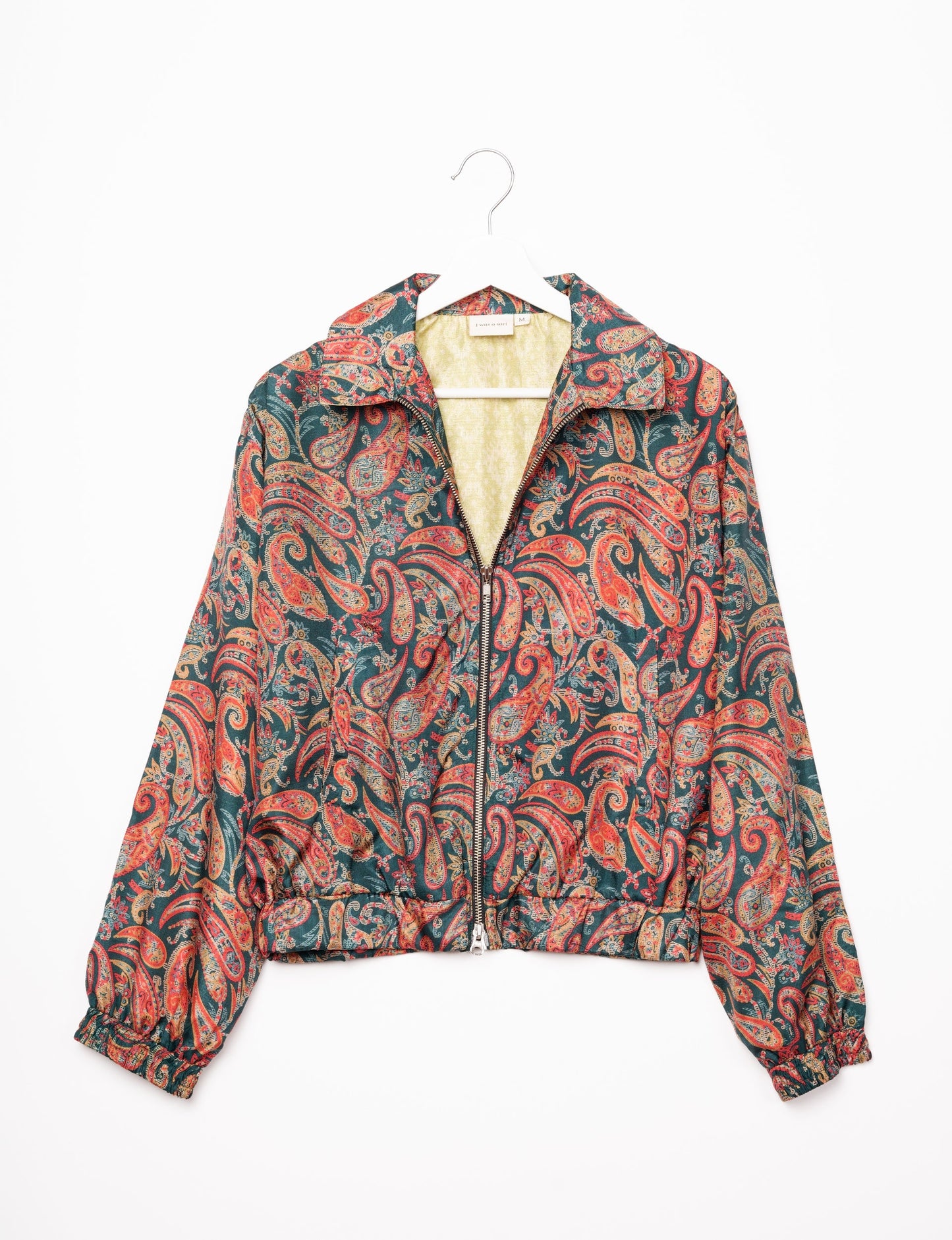 Stylish BOMBER JACKET, an upcycled clothing masterpiece with a cute cropped shape, elasticated details, and detachable metallic zipper. Contrast sari print lining adds a unique touch. Explore sustainable and eco-friendly fashion.