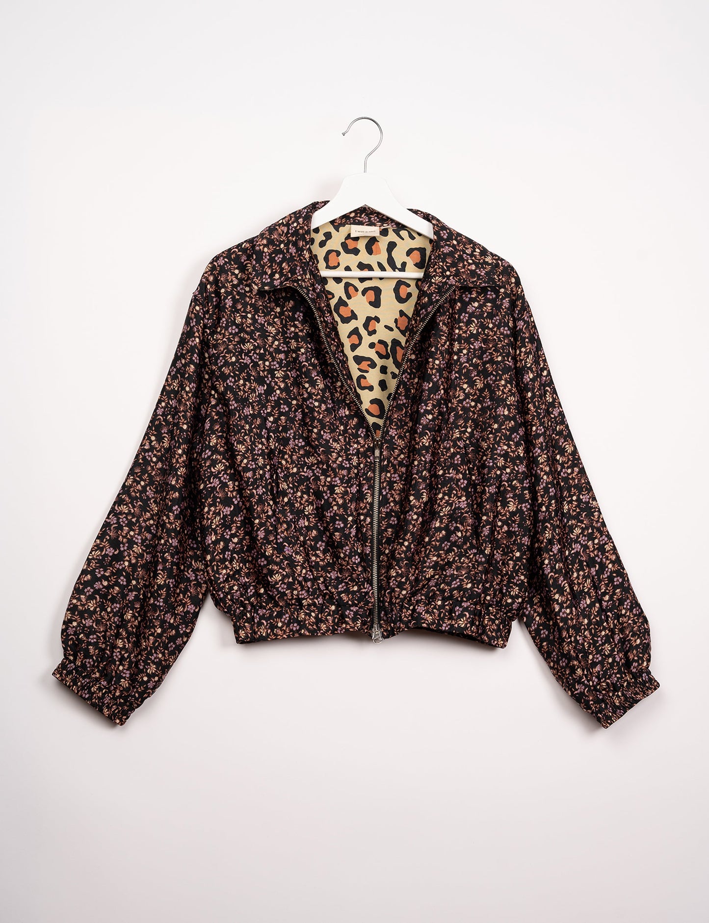 Stylish BOMBER JACKET, an upcycled clothing masterpiece with a cute cropped shape, elasticated details, and detachable metallic zipper. Contrast sari print lining adds a unique touch. Explore sustainable and eco-friendly fashion.