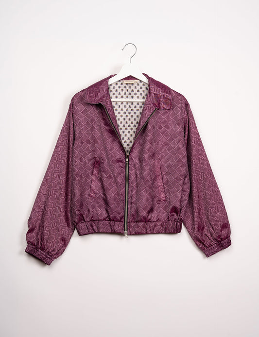 Stylish BOMBER JACKET, an upcycled clothing masterpiece with a cute cropped shape, elasticated details, and detachable metallic zipper. Contrast sari print lining adds a unique touch. Explore sustainable and eco-friendly fashion.