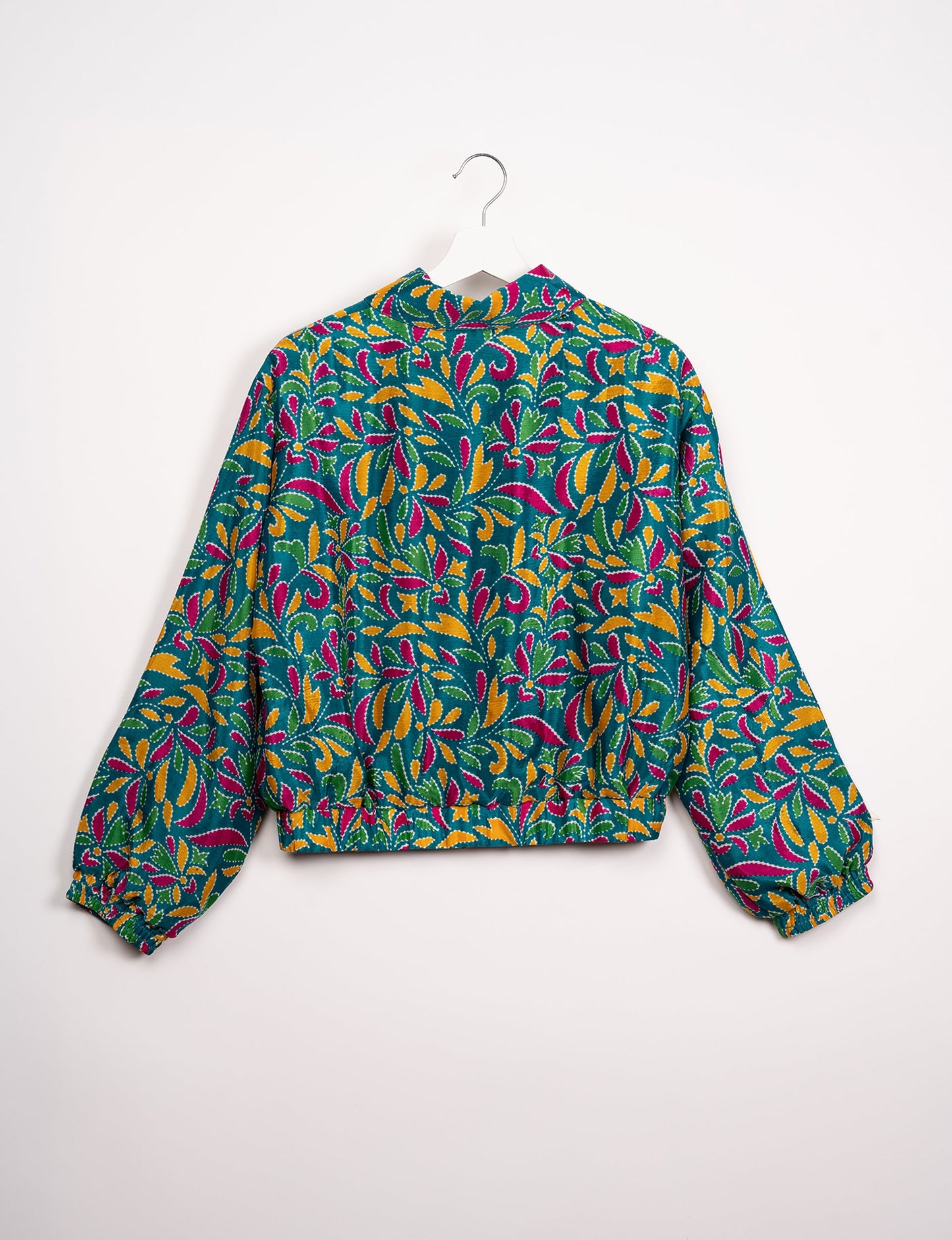 Stylish BOMBER JACKET, an upcycled clothing masterpiece with a cute cropped shape, elasticated details, and detachable metallic zipper. Contrast sari print lining adds a unique touch. Explore sustainable and eco-friendly fashion.