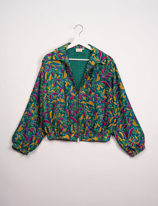 Stylish BOMBER JACKET, an upcycled clothing masterpiece with a cute cropped shape, elasticated details, and detachable metallic zipper. Contrast sari print lining adds a unique touch. Explore sustainable and eco-friendly fashion.