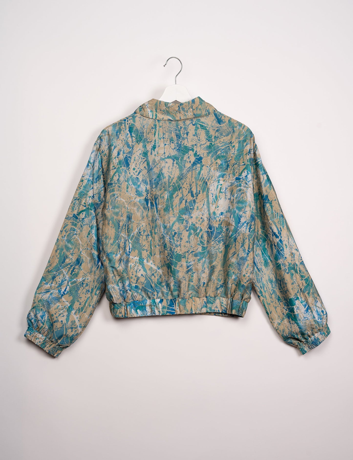 Stylish BOMBER JACKET, an upcycled clothing masterpiece with a cute cropped shape, elasticated details, and detachable metallic zipper. Contrast sari print lining adds a unique touch. Explore sustainable and eco-friendly fashion.