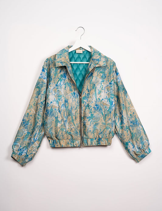 Stylish BOMBER JACKET, an upcycled clothing masterpiece with a cute cropped shape, elasticated details, and detachable metallic zipper. Contrast sari print lining adds a unique touch. Explore sustainable and eco-friendly fashion.