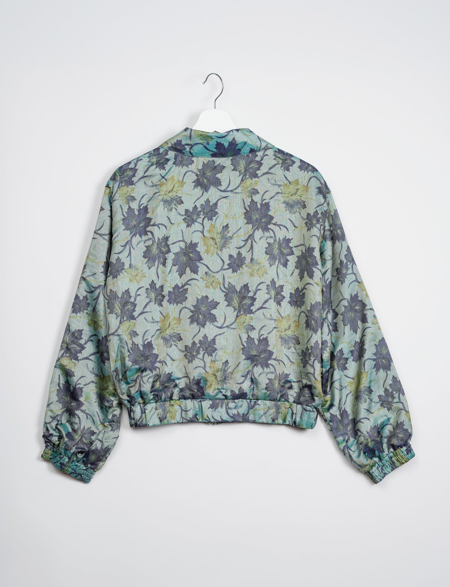 Stylish BOMBER JACKET, an upcycled clothing masterpiece with a cute cropped shape, elasticated details, and detachable metallic zipper. Contrast sari print lining adds a unique touch. Explore sustainable and eco-friendly fashion.