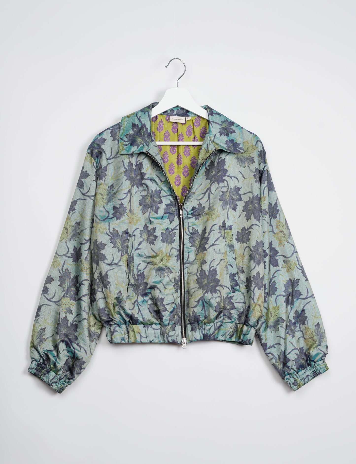 Stylish BOMBER JACKET, an upcycled clothing masterpiece with a cute cropped shape, elasticated details, and detachable metallic zipper. Contrast sari print lining adds a unique touch. Explore sustainable and eco-friendly fashion.