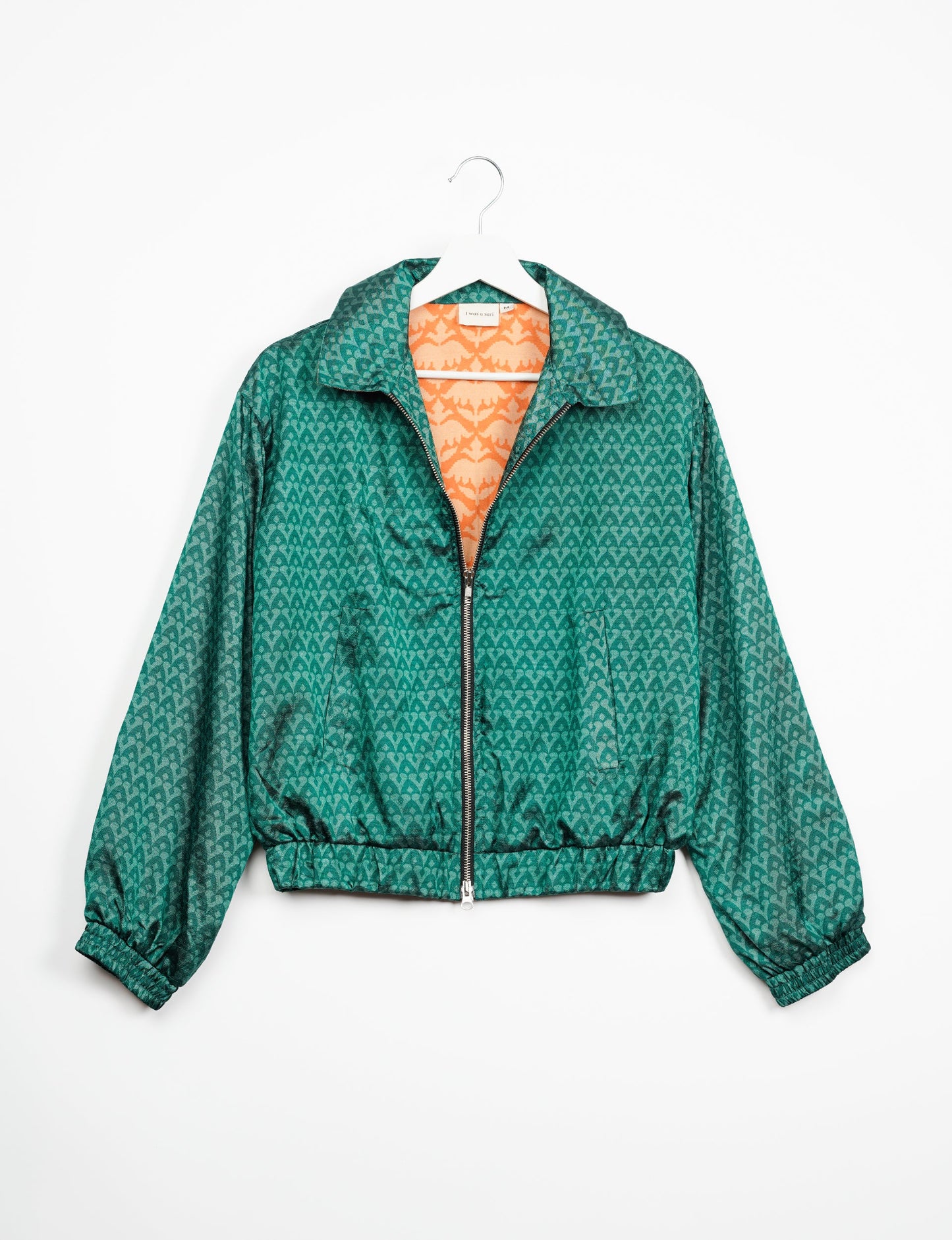 Stylish BOMBER JACKET, an upcycled clothing masterpiece with a cute cropped shape, elasticated details, and detachable metallic zipper. Contrast sari print lining adds a unique touch. Explore sustainable and eco-friendly fashion.