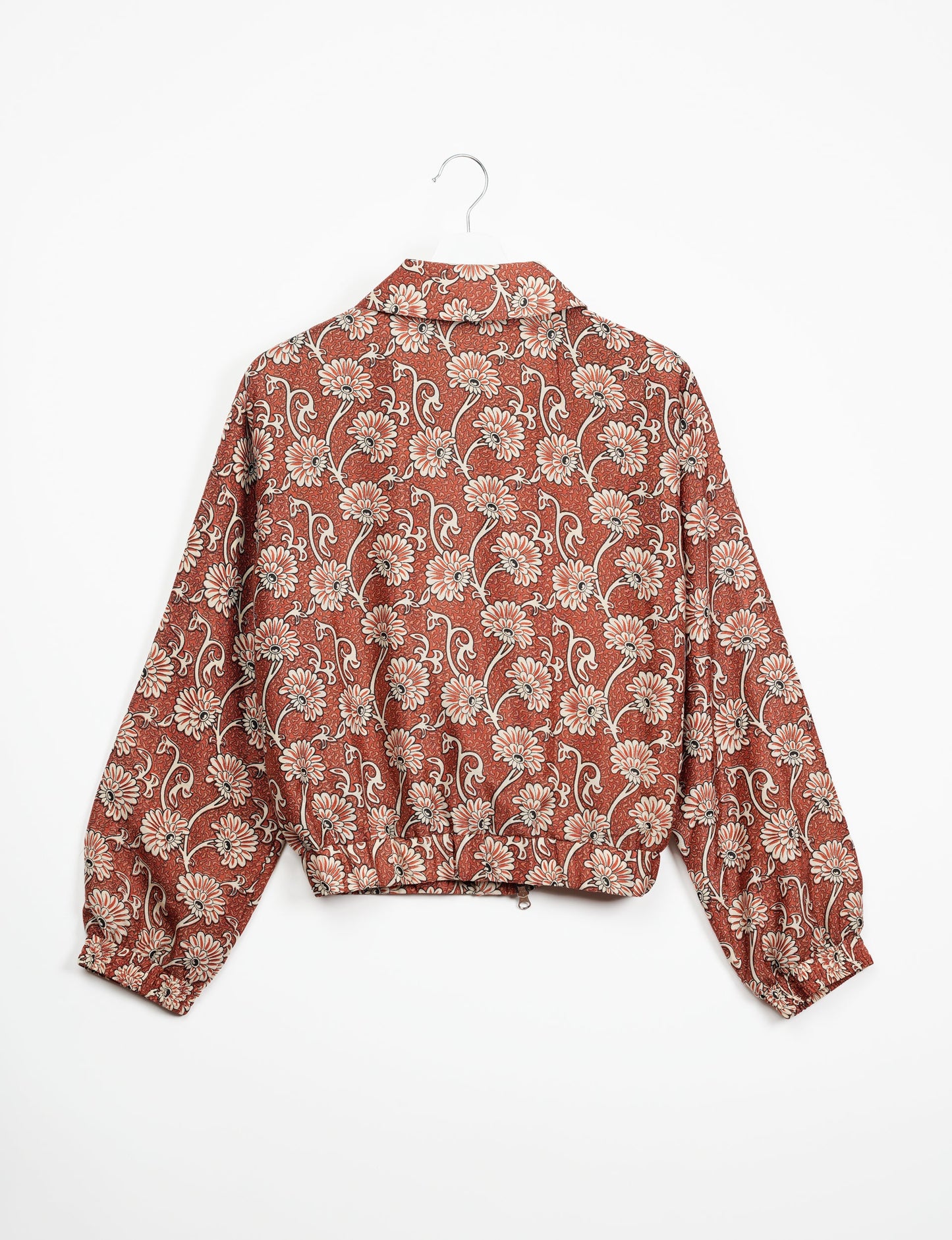 Stylish BOMBER JACKET, an upcycled clothing masterpiece with a cute cropped shape, elasticated details, and detachable metallic zipper. Contrast sari print lining adds a unique touch. Explore sustainable and eco-friendly fashion.